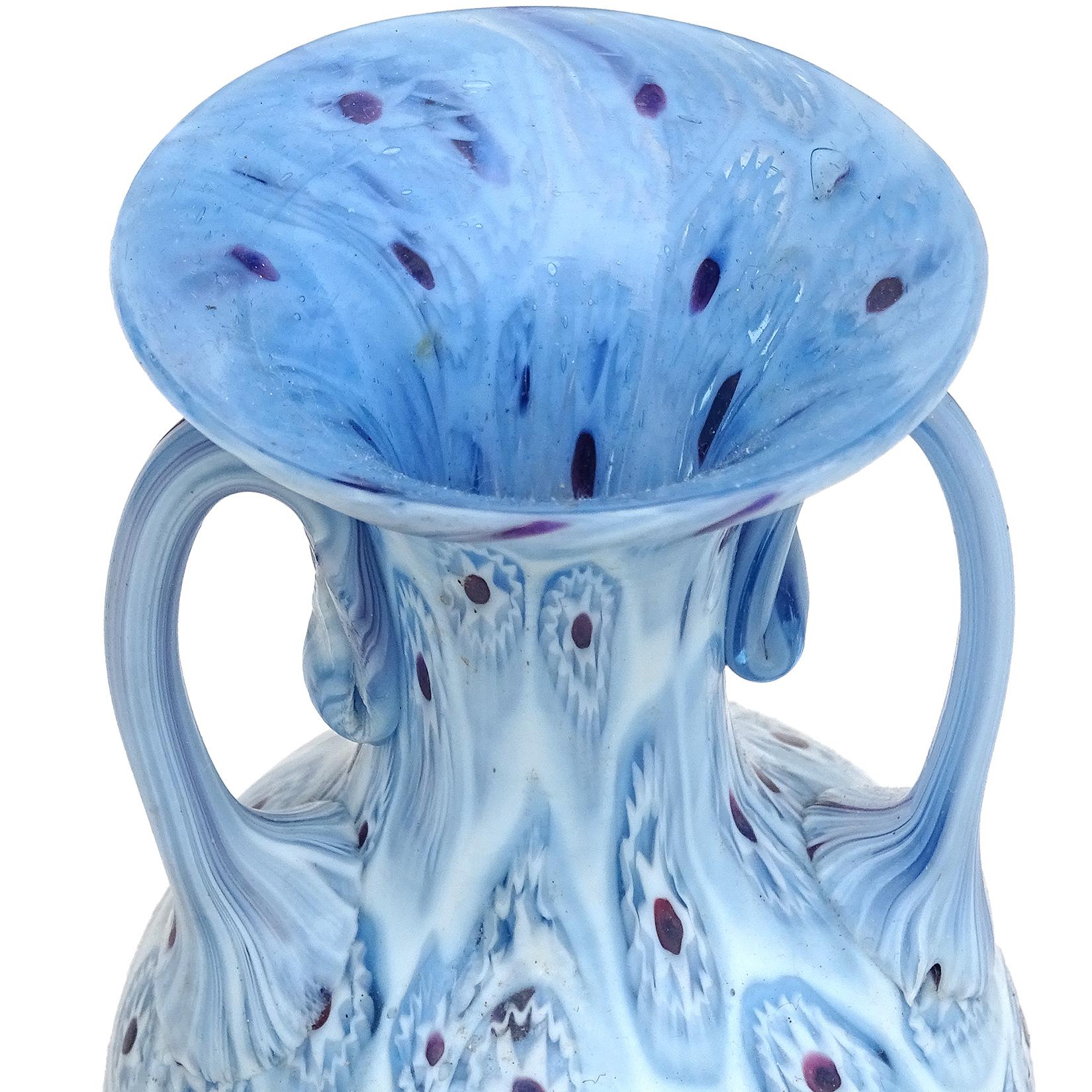 Beautiful antique Murano hand blown millefiori mosaic Italian art glass decorative cabinet vase. Documented to the Fratelli Toso Company, circa 1910-1930. The vase has a sky blue flower murine design with dark red centers, and layers of darker blue.