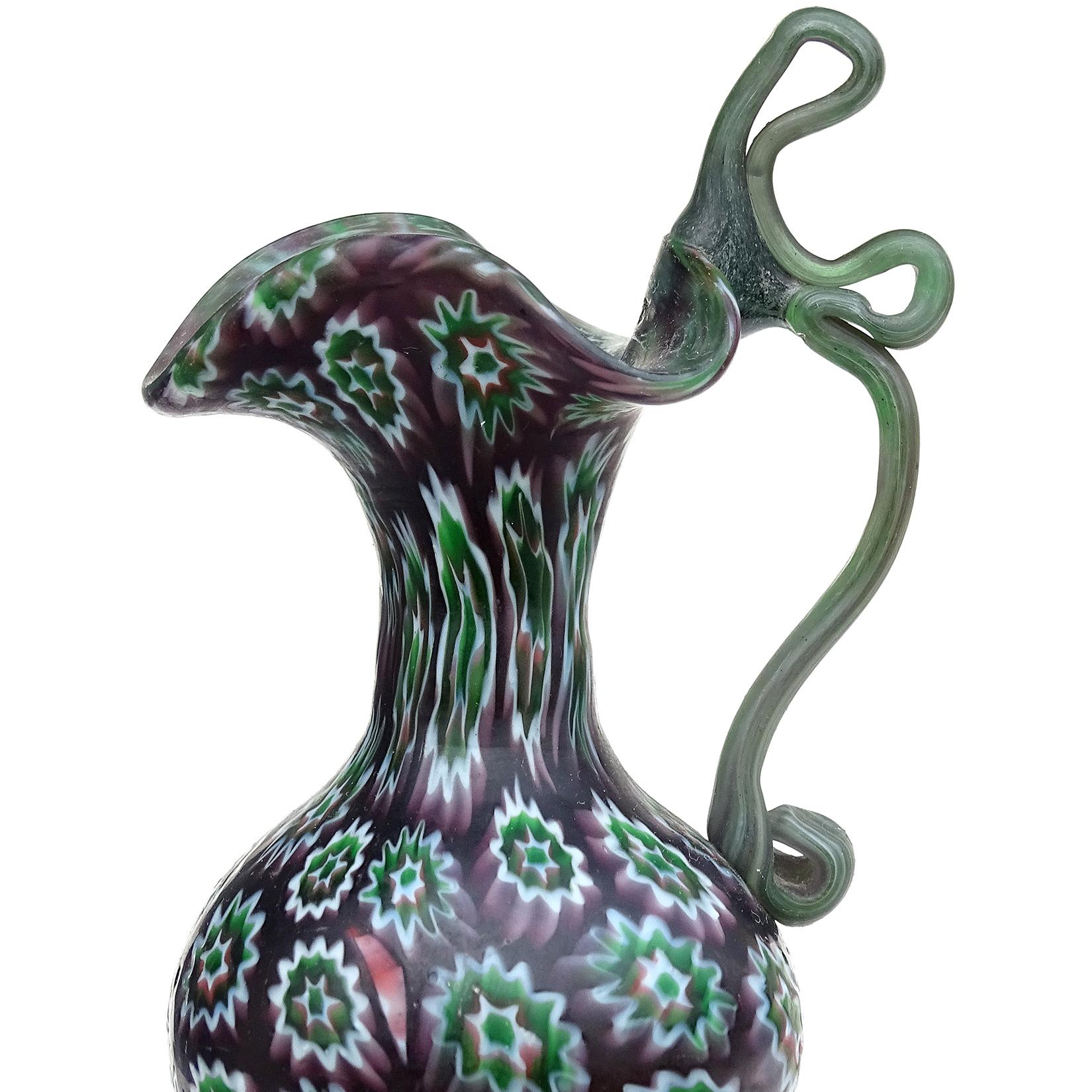Beautiful antique Murano hand blown millefiori mosaic Italian art glass decorative cabinet vase. Documented to the Fratelli Toso Company, circa 1900-1910. Art Nouveau era. The vase has a dark and rich purple base color, with white, green and purple