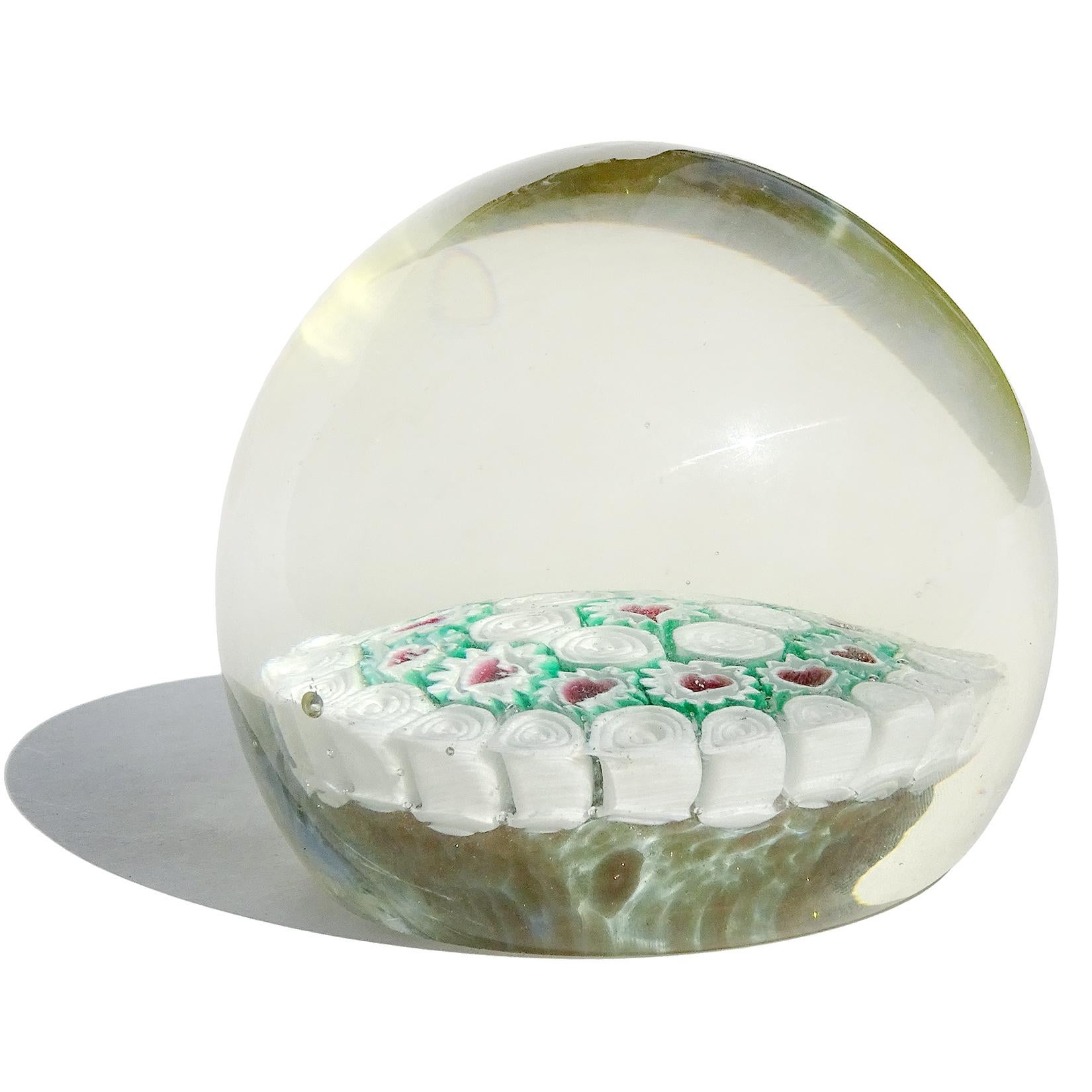 Beautiful and rare, vintage Murano hand blown millefiori flowers with heart centers and bullseye murrines Italian art glass paperweight. Documented to the Fratelli Toso Company. It has a red, white and green color combination. The piece has glittery