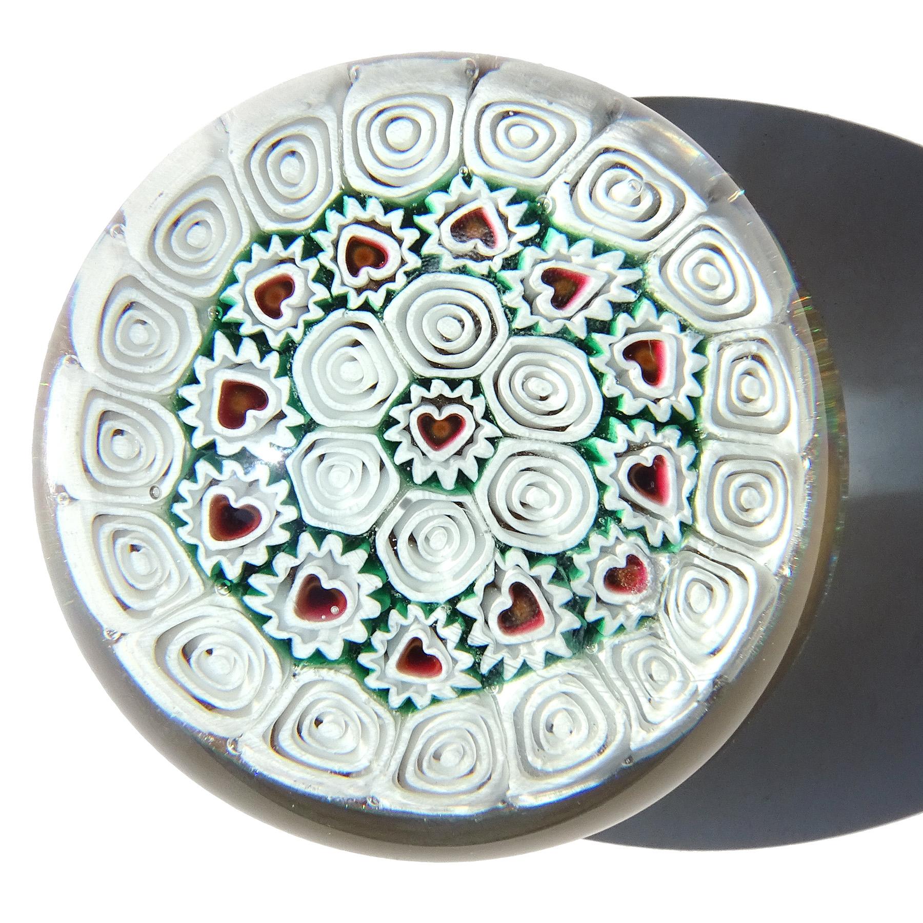 Beautiful and rare, vintage Murano hand blown millefiori flowers mosaic with heart centers and bullseye murrines Italian art glass paperweight. Documented to the Fratelli Toso company. It has a red, white and green color combination. The murrines