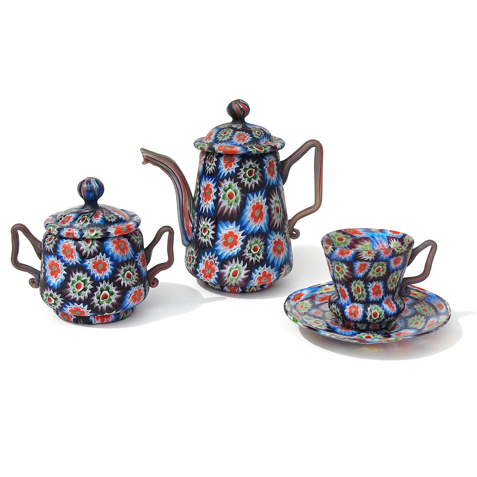 Beautiful antique Murano hand blown millefiori flower mosaic Italian art glass teapot, sugar bowl, with teacup and saucer set. Documented to the Fratelli Toso Company, circa 1910-1930. Bold design, in an almost checkered pattern on each piece. The
