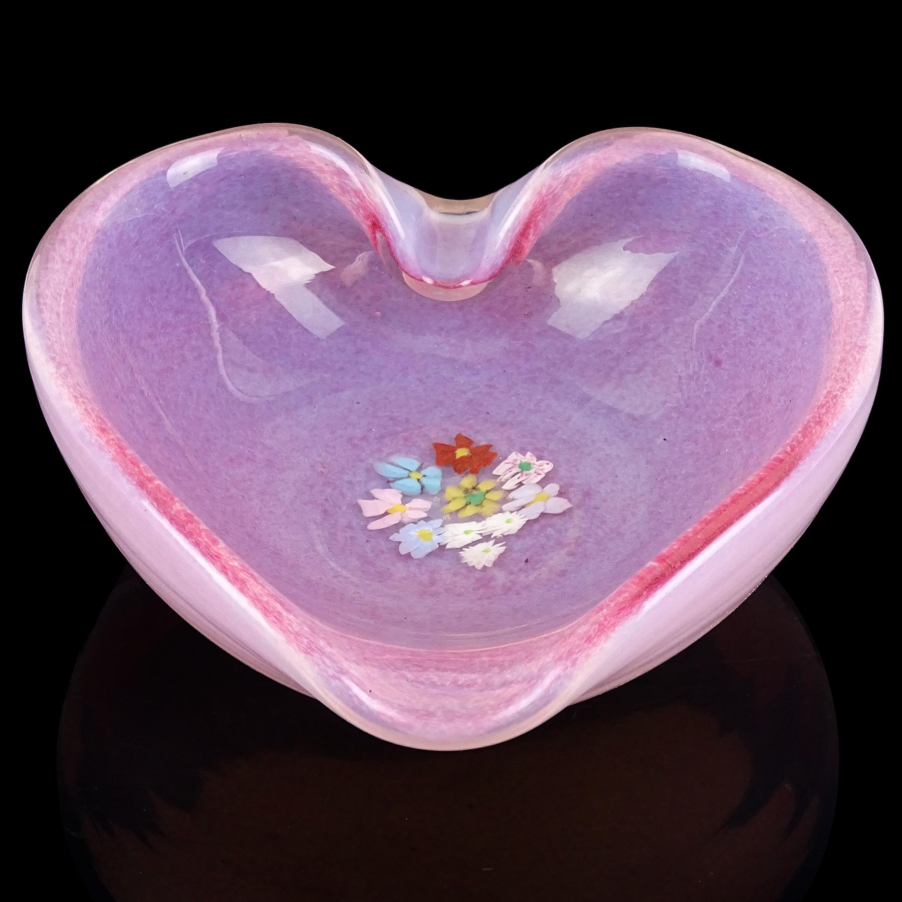 Beautiful vintage Murano hand blown pink and opalescent Italian art glass heart shaped bowl with wild flower murrines. The piece is documented to the Fratelli Toso, circa 1950s. The bowl has a transparent white opal glass underneath, with pink dots