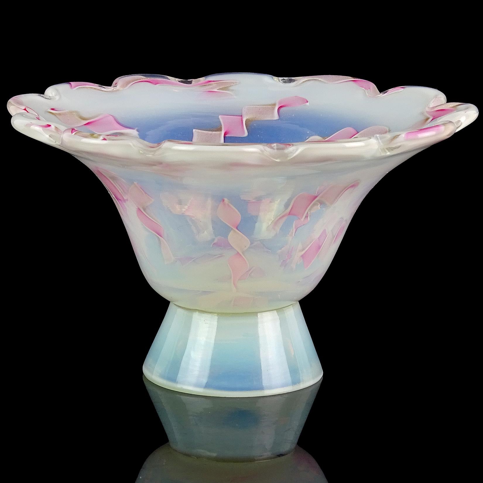 Beautiful Murano hand blown opalescent and twisted pink ribbons Italian art glass footed bowl. Documented to the Fratelli Toso Company, circa 1956. The design, in vase form, is published in the Fratelli Toso book (see last photo). The ribbons have