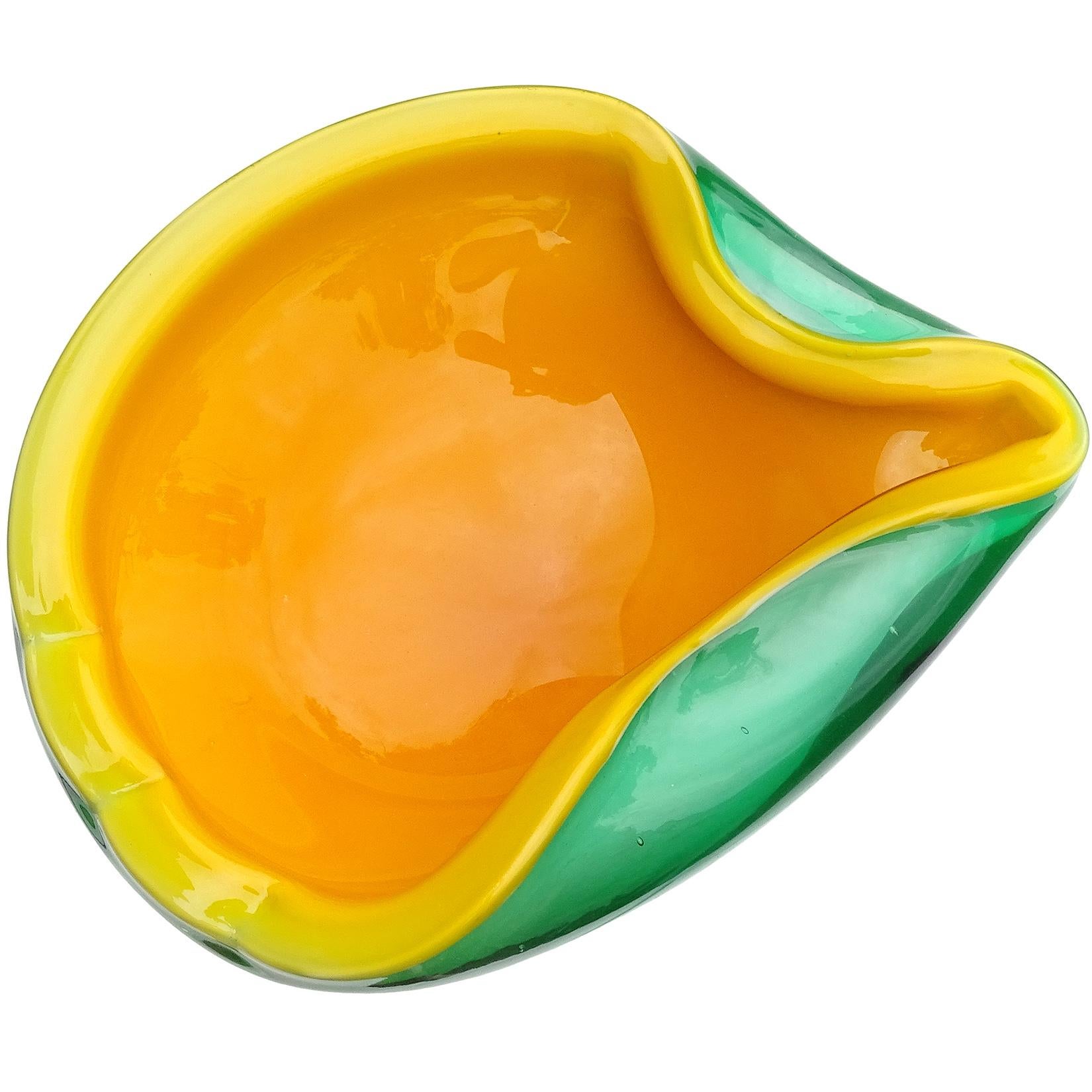 Beautiful Murano hand blown orange and green Italian art glass tropical bowl. Documented to the Fratelli Toso Company. The rich bright orange pops inside the green mango / melon color. Measures: 8