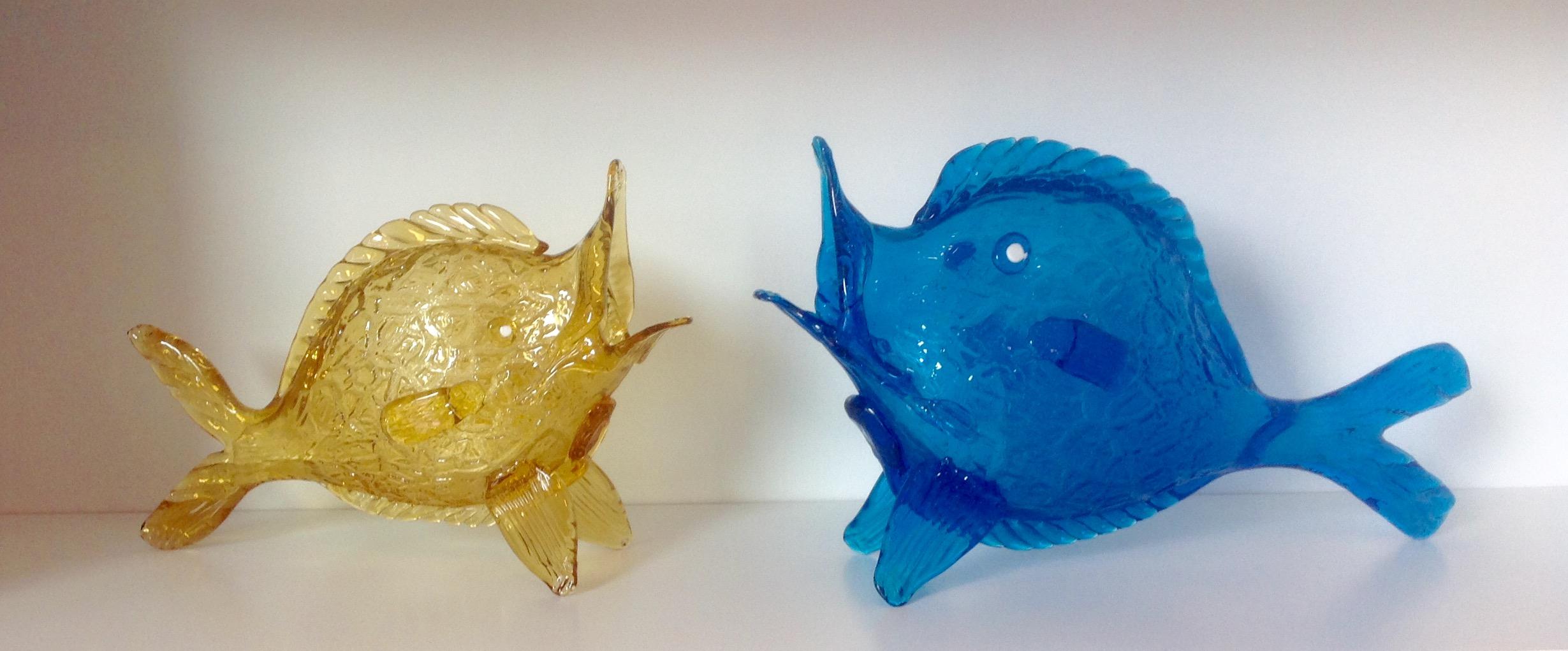 Rare pair of fish sculptures by Fratelli Toso circa 1930s in Murano glass. Blue fish is 13 inches wide, by 7.75 inches tall by 3.5 inches deep. Yellow fish is 10.25 inches wide, by 7.25 inches tall, by 3 inches deep.