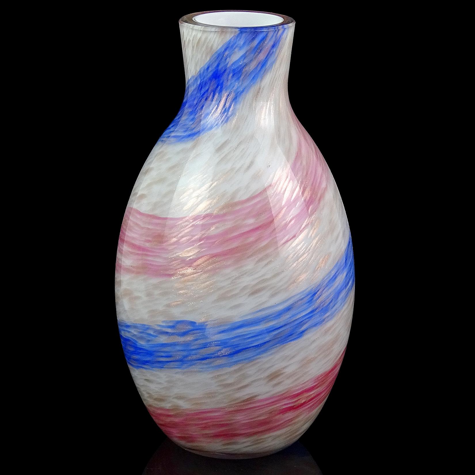 Beautiful vintage Murano hand blown pink and blue candy stripe and copper aventurine flecks Italian art glass flower vase. Documented to the Fratelli Toso company, circa 1950-60s. The piece has a thick layer of glass over white, which creates the