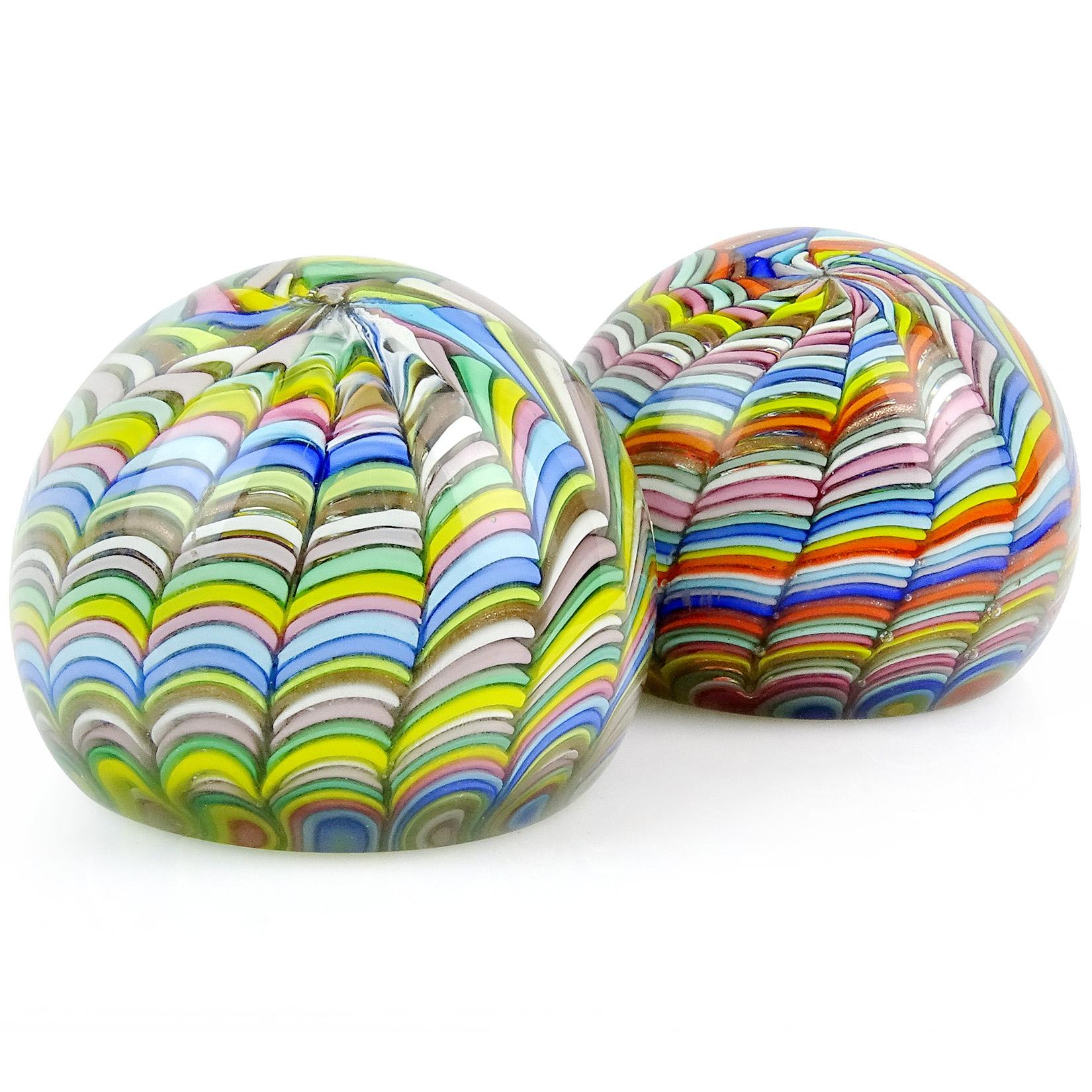 Priced per item (2 available as shown). Beautiful Murano hand blown rainbow stripe ribbons Italian art glass paperweights. Documented to the Fratelli Toso Company. One is a little softer color than the other. They have alternating pink, white, blue,