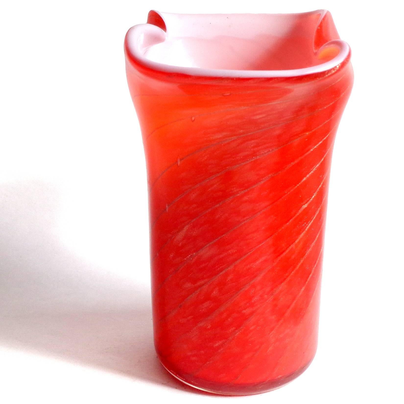 Beautiful vintage Murano hand blown bright red over white and copper aventurine Italian art glass flower vase. Documented to the Fratelli Toso company. Published. The piece has a candy cane swirl and glitters in the light. Midcentury era. Measures 6