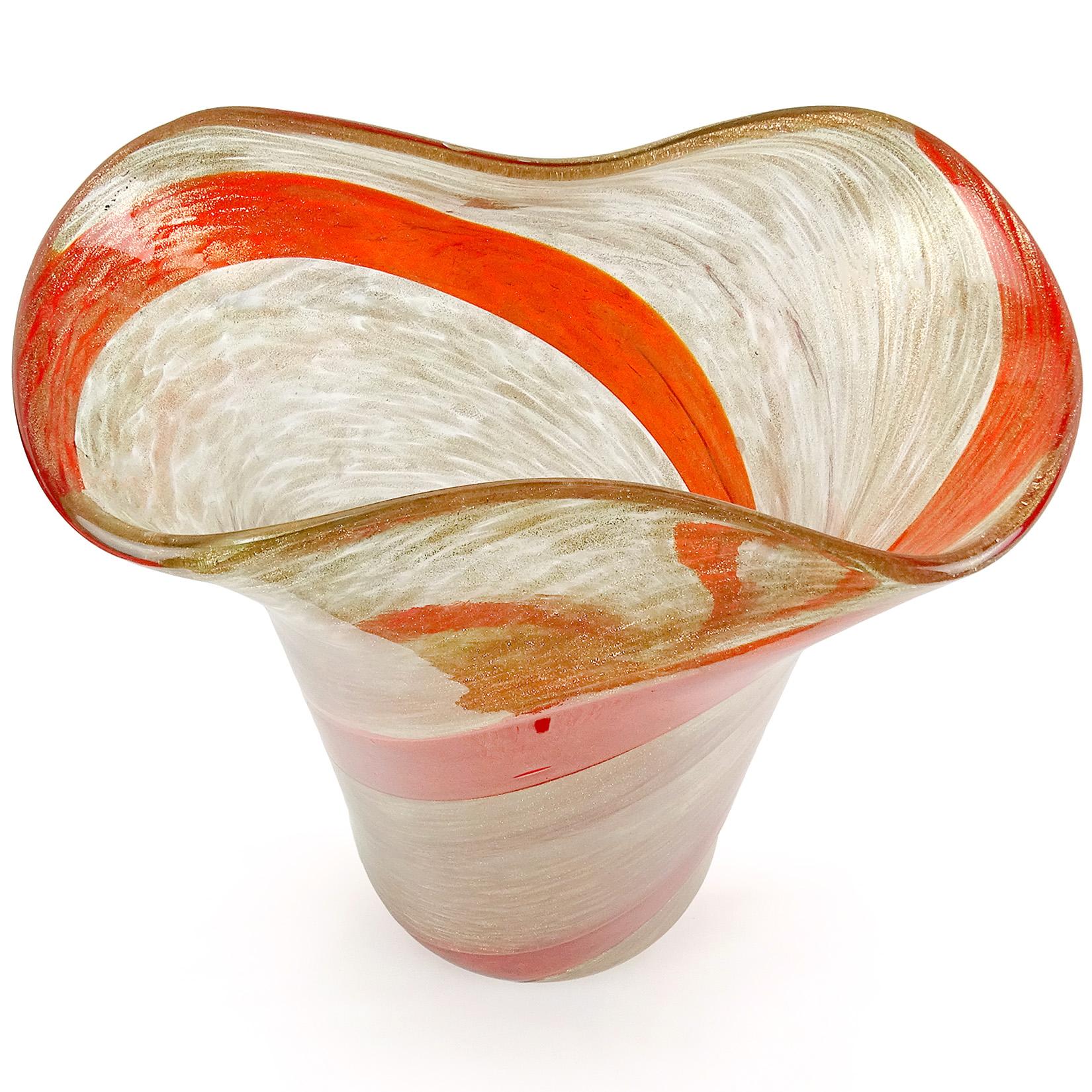 Beautiful Murano hand blown red orange candy stripe ribbon Italian art glass flower vase. Documented to the Fratelli Toso company, circa 1950s. The piece has a pinched rim, profusely covered in copper aventurine that glitters in any light. Still