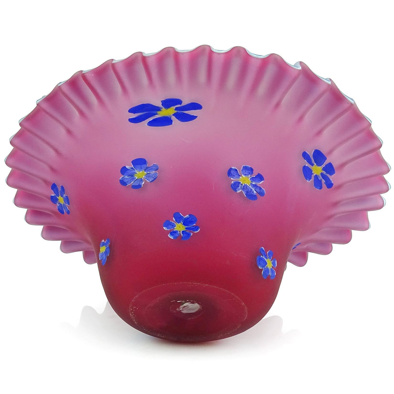 Beautiful vintage Murano hand blown dark red - pink and inside light blue satin surface Italian art glass bowl. Documented to the Fratelli Toso company. The bowl has blue millefiori flowers over the outside, and a crimped edge. It is soft to the