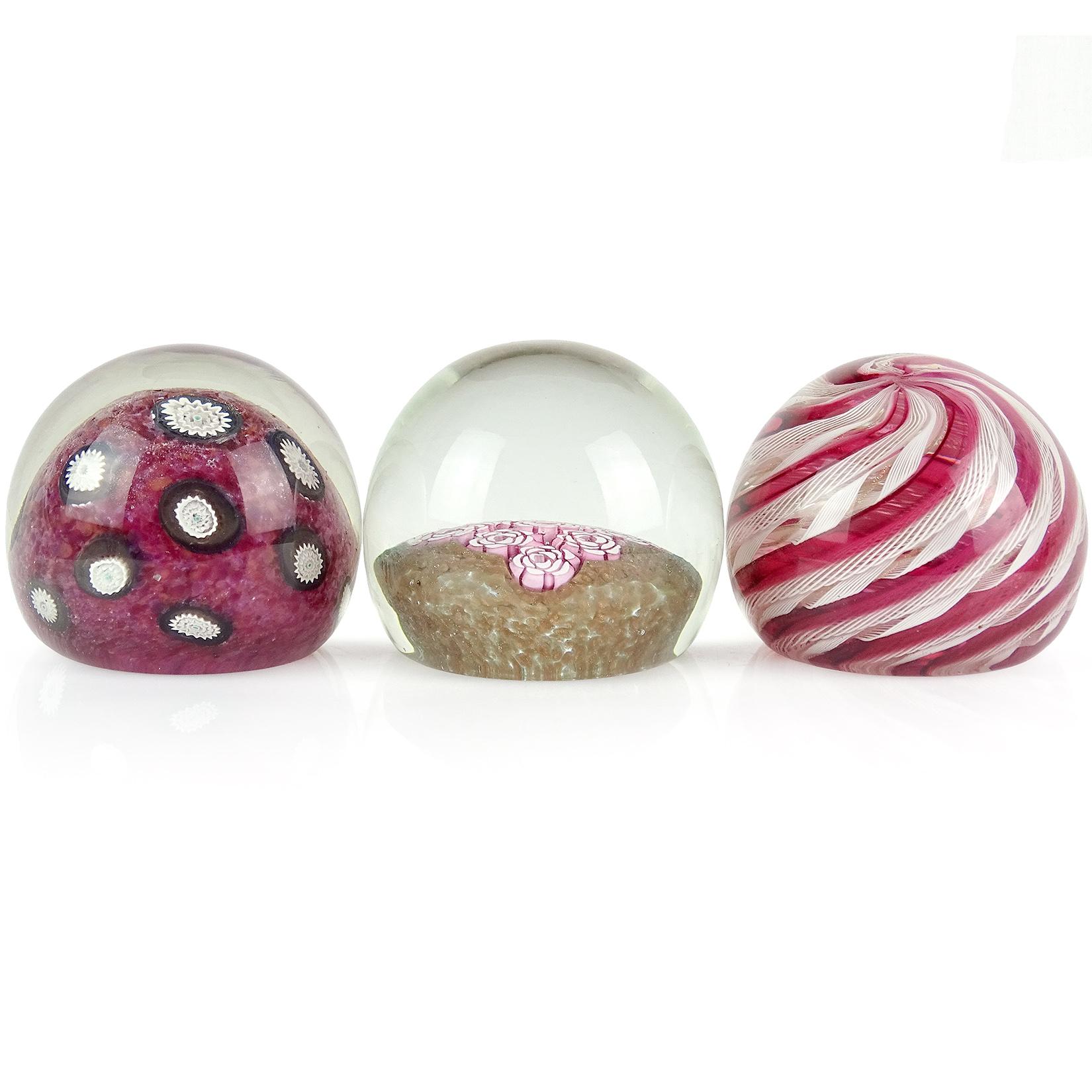 Priced per item. Beautiful Murano hand blown Italian art glass paperweights. Documented to the Fratelli Toso company. The first is a red dots ground with white and black millefiori flower pieces. Next, a white Zanfirico ribbons and clear red ribbons