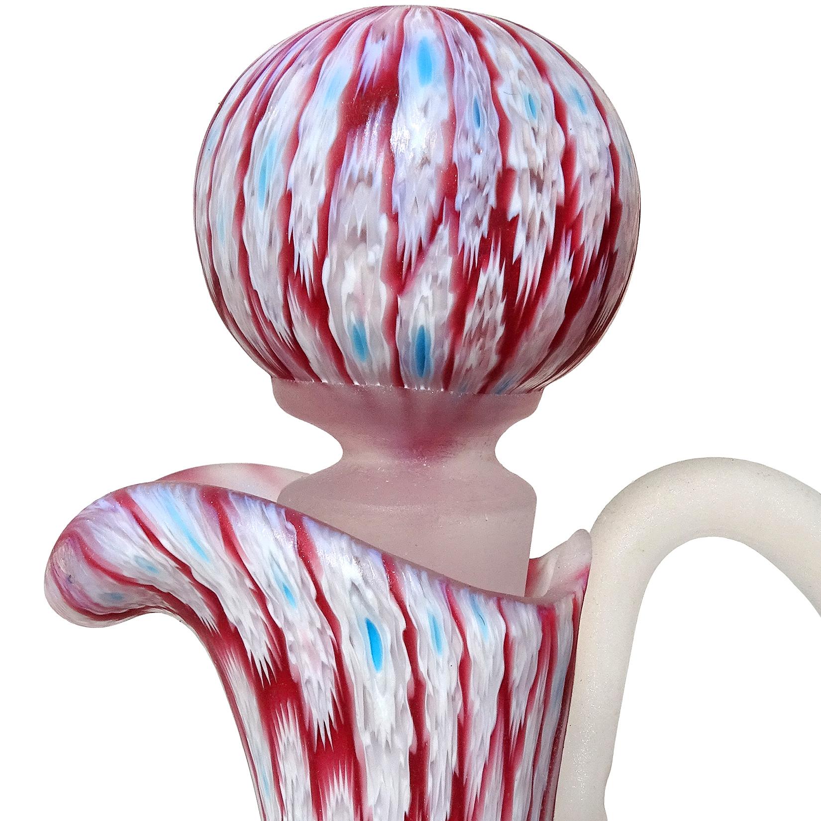 Beautiful, vintage Murano hand blown white flower Millefiori Murrina with on red / dark pink Italian art glass mosaic ewer, cruet. Documented to the Fratelli Toso company. The flowers are made in multiple layers of glass, with the center dot in a