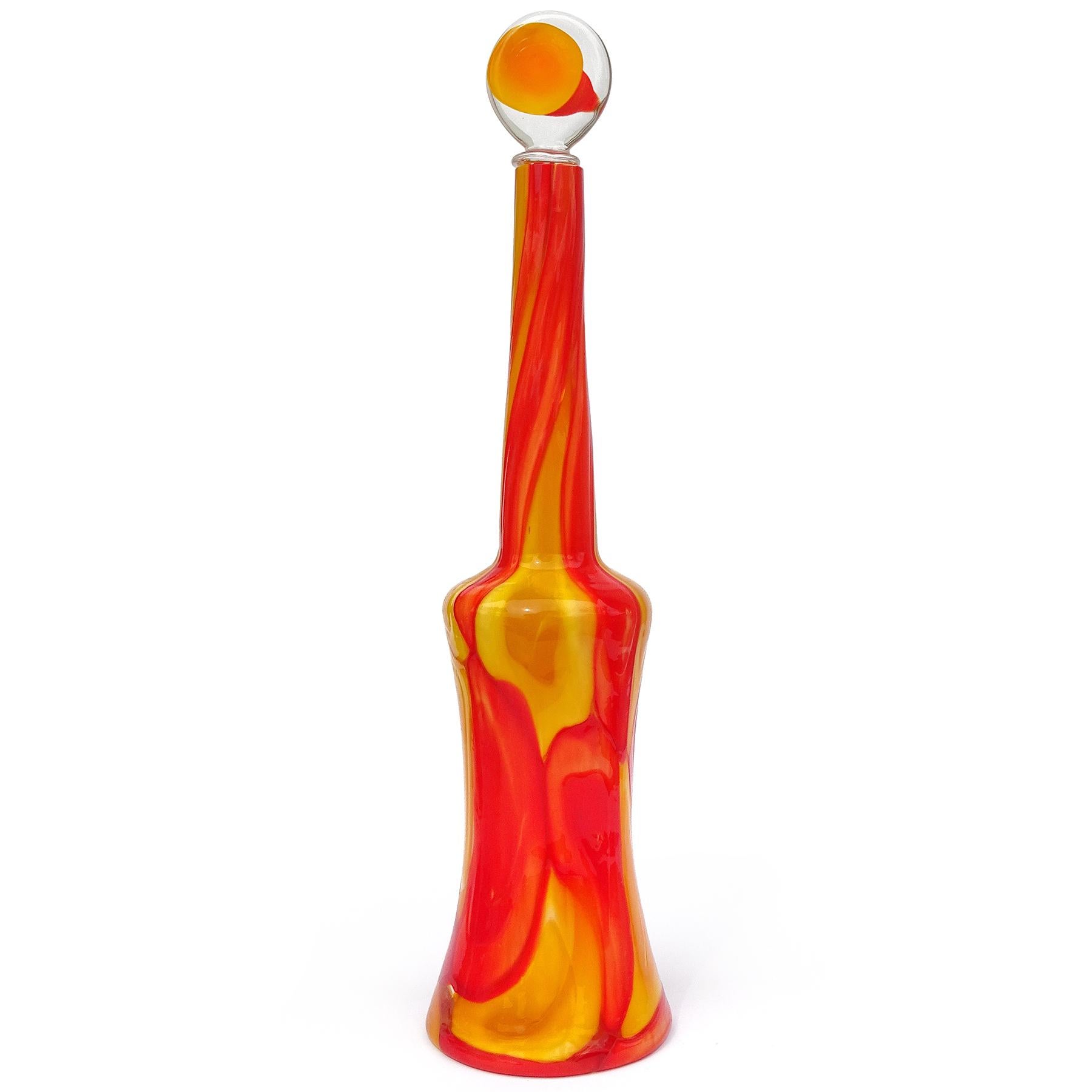 Beautiful, tall, and very rare Murano hand blown red-orange and yellow-orange spots Italian art glass decanter with original stopper. Documented to designer Ermanno Toso for the Fratelli Toso company, circa 1962. The drawing of this piece is
