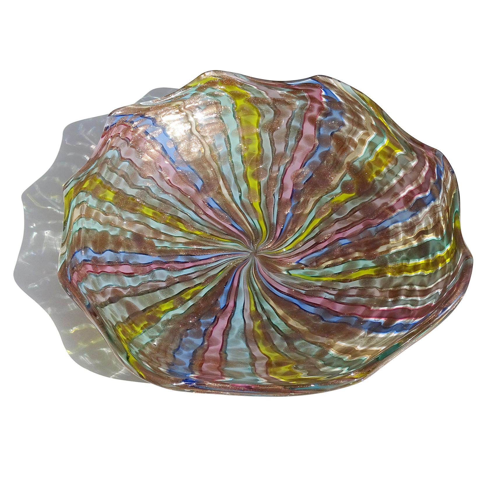 Beautiful, extra large, and colorful vintage Murano hand blown rainbow Filigrana ribbons and aventurine spots Italian art glass centerpiece bowl. Documented to the Fratelli Toso company. The bowl has an oval shape, ruffle rim, with alternating bands