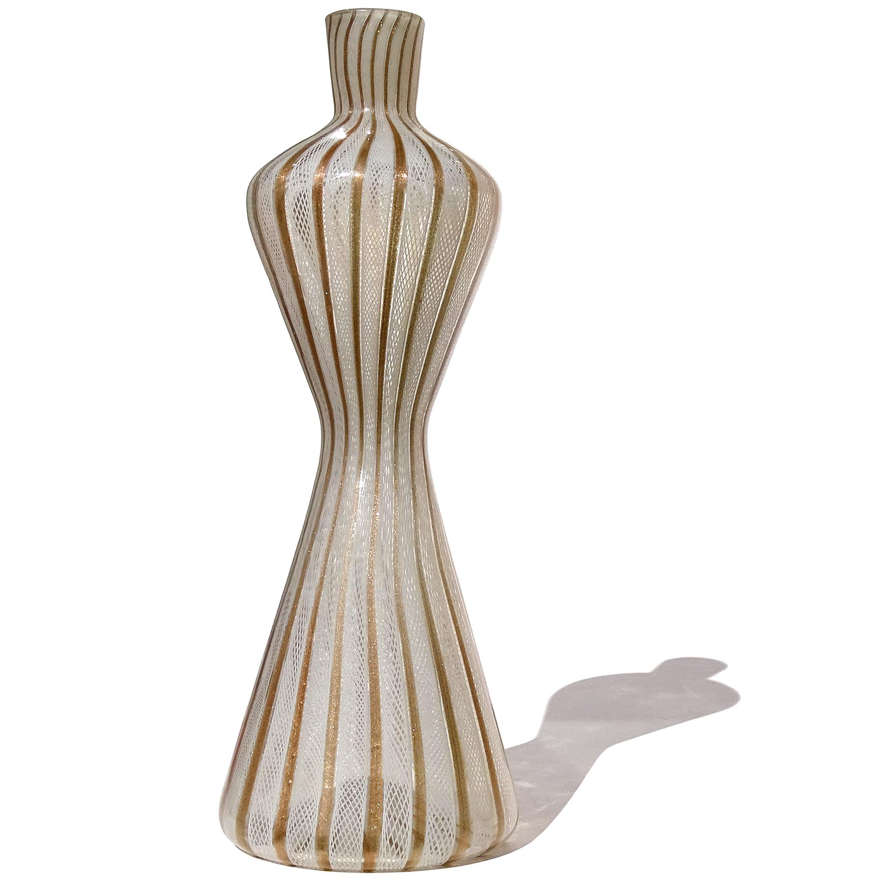 Beautiful and tall, vintage Murano hand blown white Zanfirico ribbons and copper aventurine flecks Italian art glass decorative hourglass corseted vase. It is documented to the Fratelli Toso company. The vase has a cinched waist, with wide shoulders
