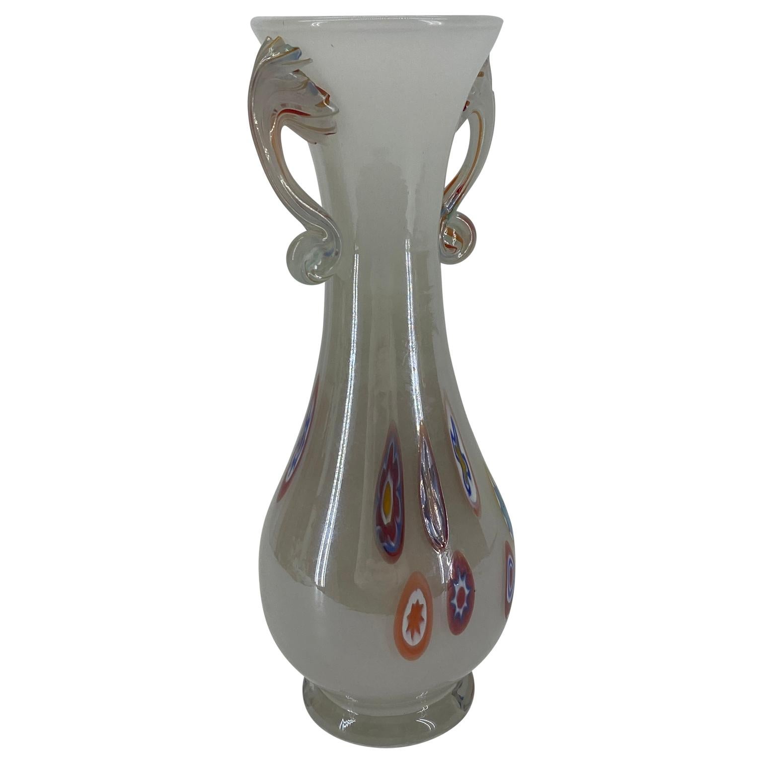 Vintage Murano Italian art glass vase. This lovely vase is hand blown opalescent white with colorful murrines. Documented to the Fratelli Toso Company. The vase has orange, white, blue, yellow, green, purple flowers in different combinations and