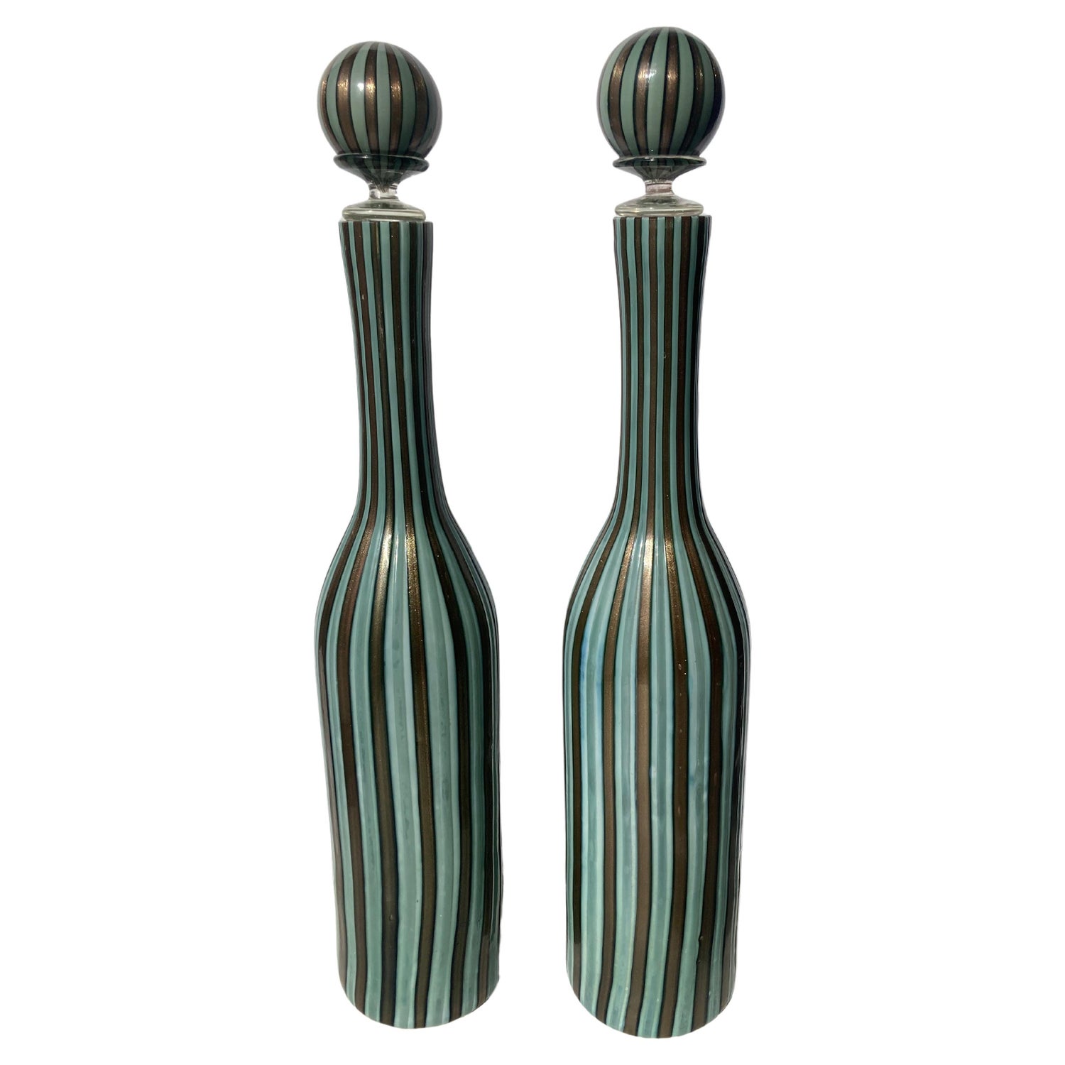 https://a.1stdibscdn.com/fratelli-toso-pair-murano-glass-decanters-bottles-with-stoppers--for-sale/f_8089/f_311867621667782531799/f_31186762_1667782532973_bg_processed.jpg?width=1500