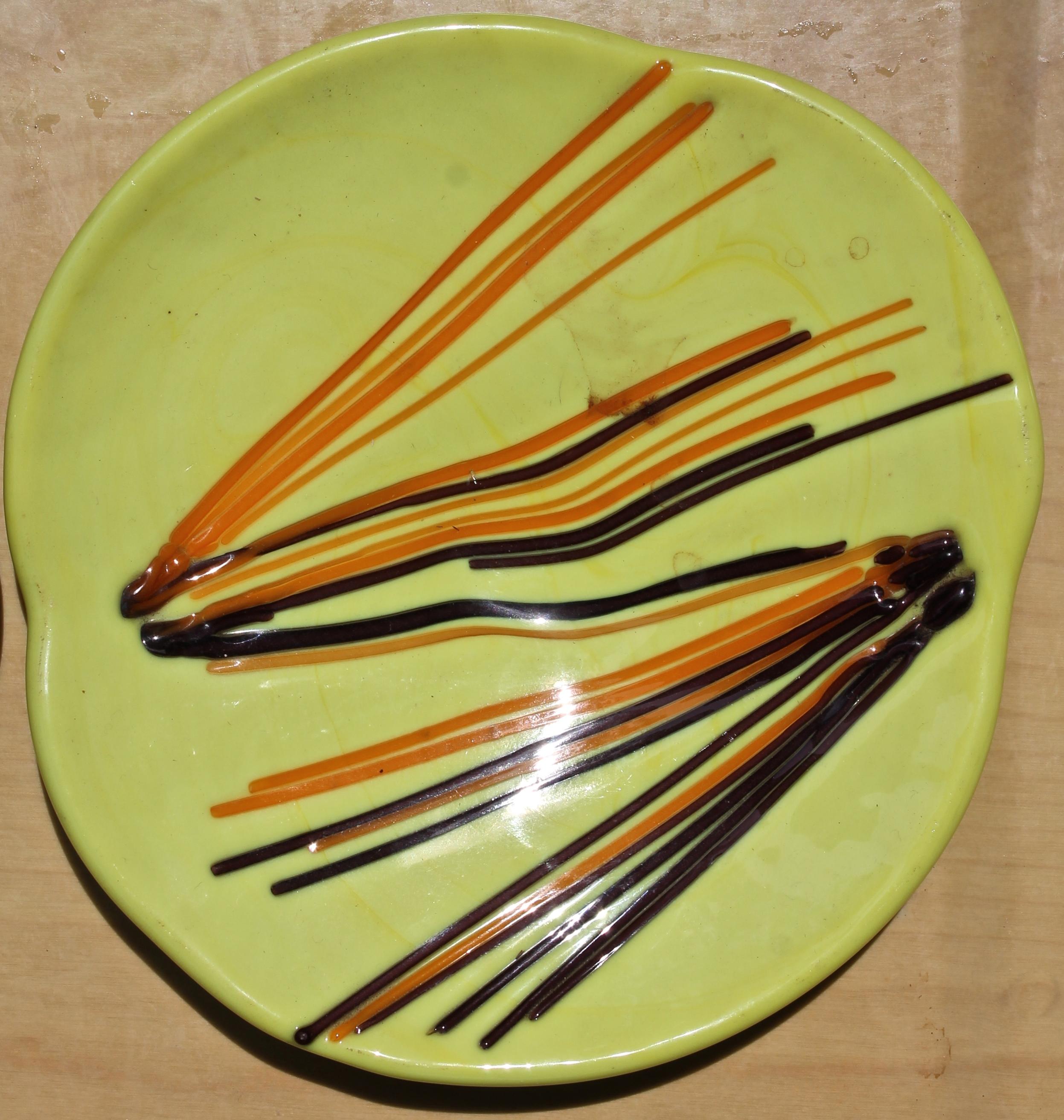 Heavy yellow pasta glass with orange and brown glass rods pressed into the surface. 8 1/4 x 7 3/4 x 1 5/8