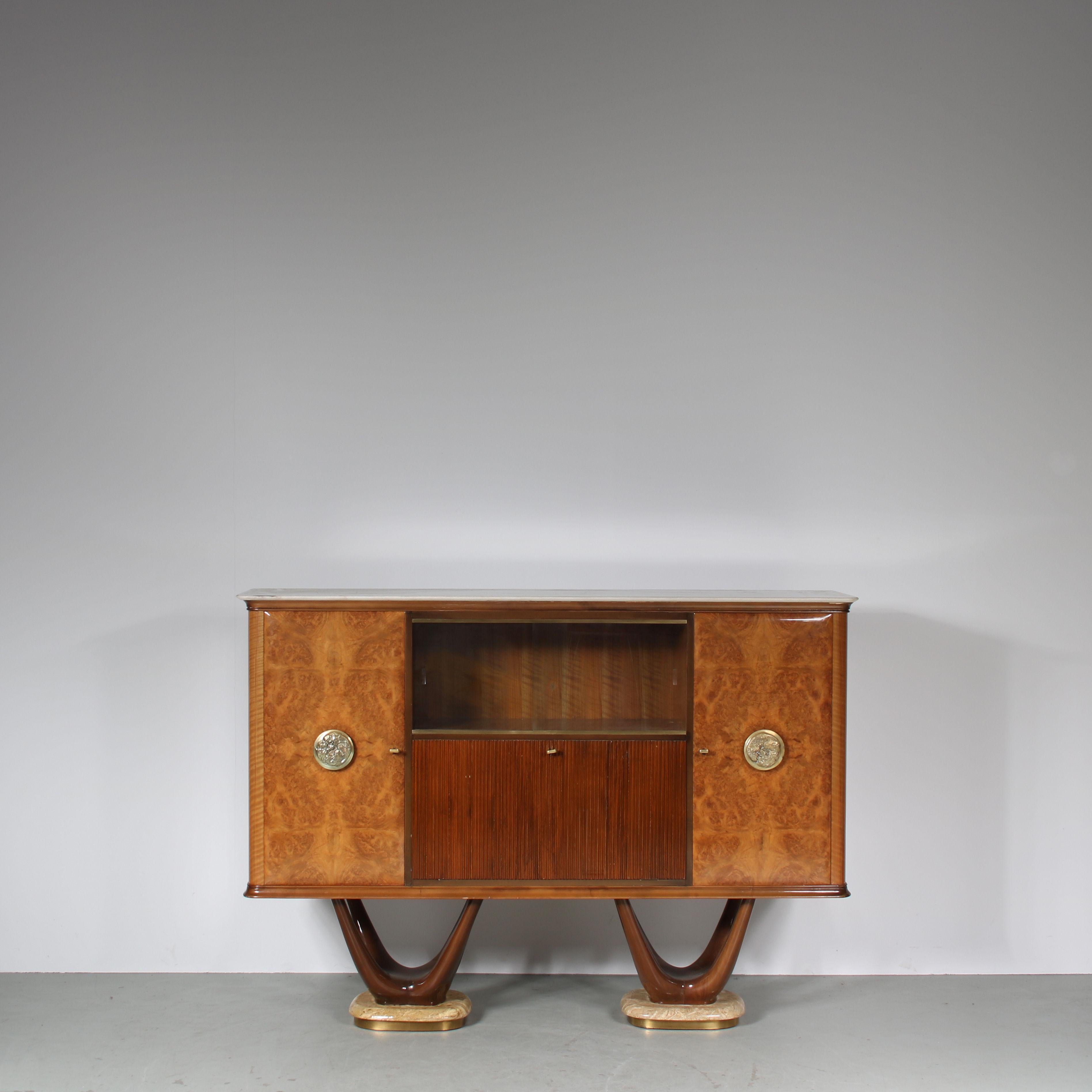 An impressive sideboard by Fratelli Turri from Italy, manufactured around 1950.

This quality piece is made of high quality burlwood. This materials provides a beautiful pattern in the wood and has a wonderful gloss finish. Bronze door knobs, marble