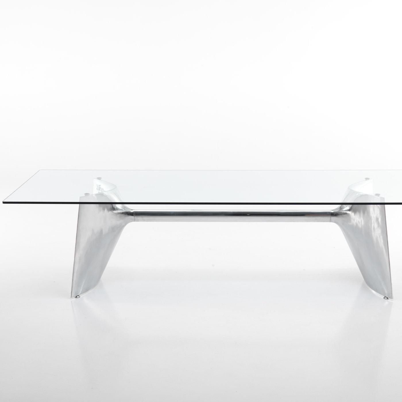 Designed by Jeff Miller, this elegant table showcases a stunning combination of materials that will enliven a modern dining room with shimmering style. The rectangular top is fashioned of extra-clear tempered glass that allows full view of the