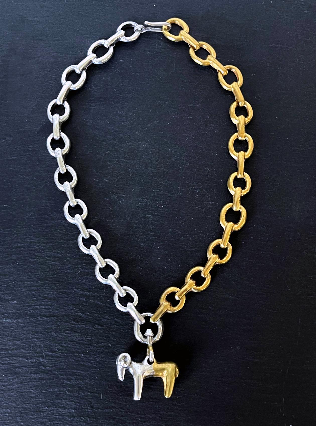 A cast bronze necklace titled 