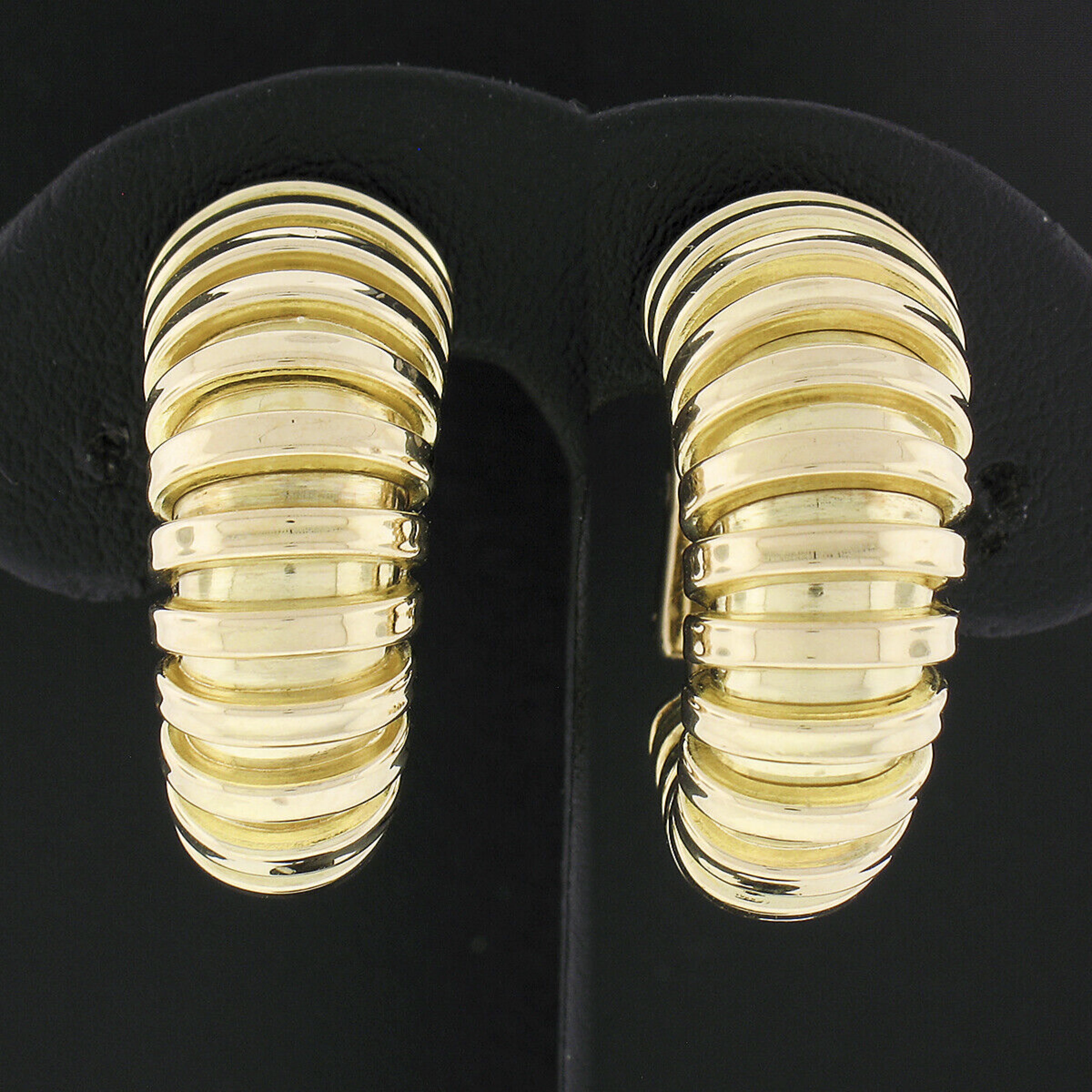 Here we have 100% authentic hoop huggie clip-on earrings made by the famous designer Fred from Paris, France. The earrings are crafted from solid 14k yellow gold and feature an elegant grooved design that graduates in width from the top to the