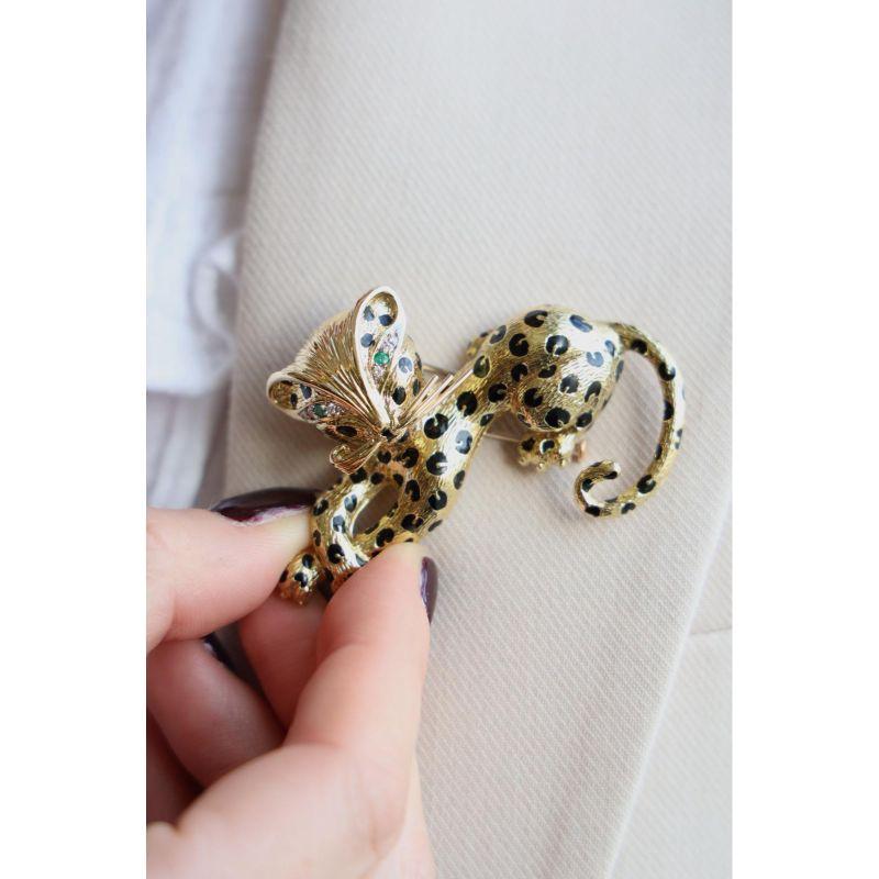 Panther brooch signed by Fred. in yellow gold 750 thousandths (18 carats). 4 diamonds of about 0.010 ct each. about G-VS; 2 diamonds of about 0.015 ct each. 2 emeralds of about 0.15 ct each. length of the panther: 5.88 cms. height: 3.88 cms. total