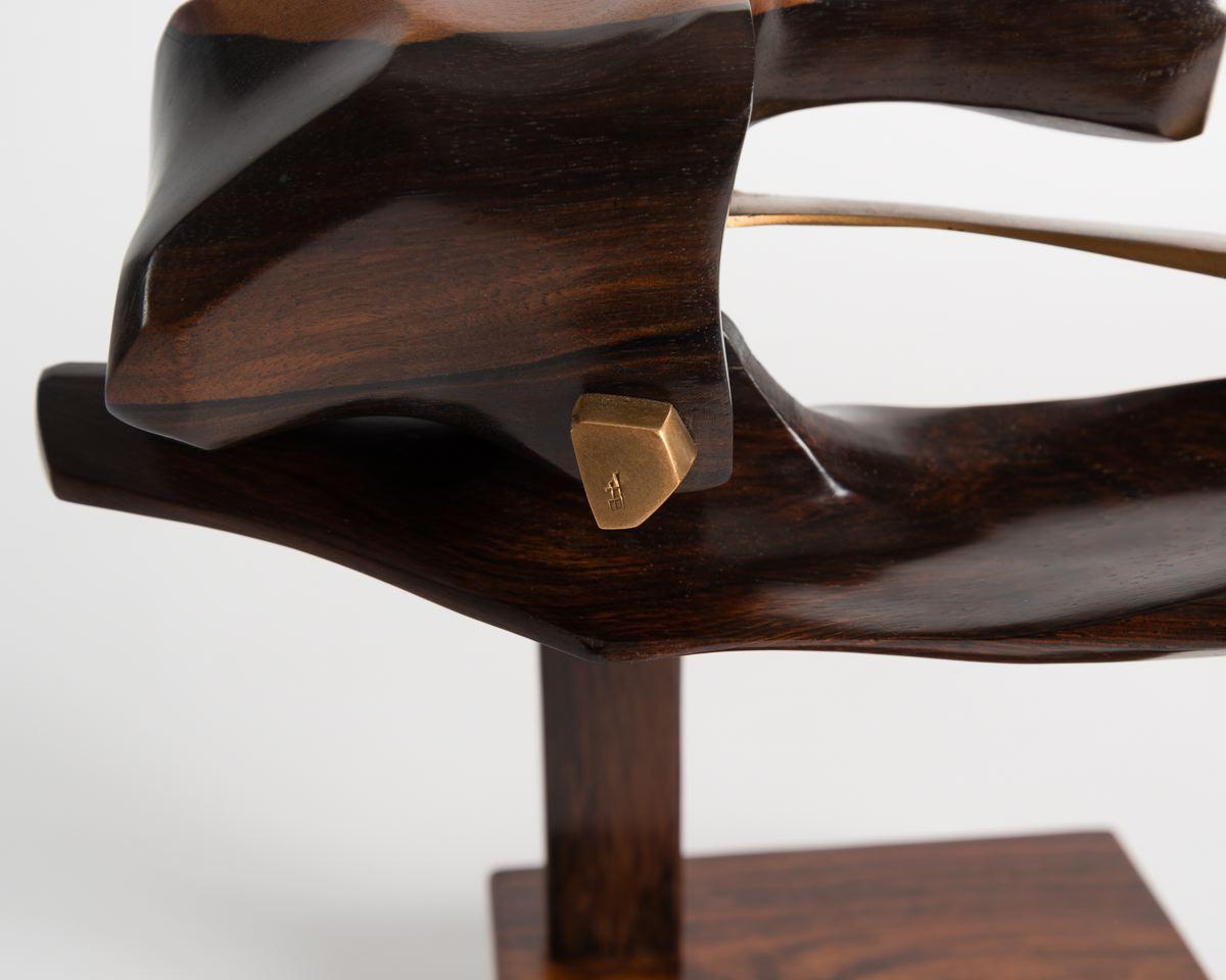 An unique piece composed of bronze and fruitwood parts that move on a hinge, evincing the flight of a bird.

Fred Brouard was renowned in his time for bringing unique curves, striking finishes, and bold designs to the fore of late 20th century