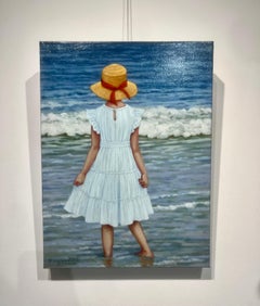 "Viaggio in solitaria": una ragazza con un vestito bianco e un cappello da sole con un nastro si immerge nell'oceano