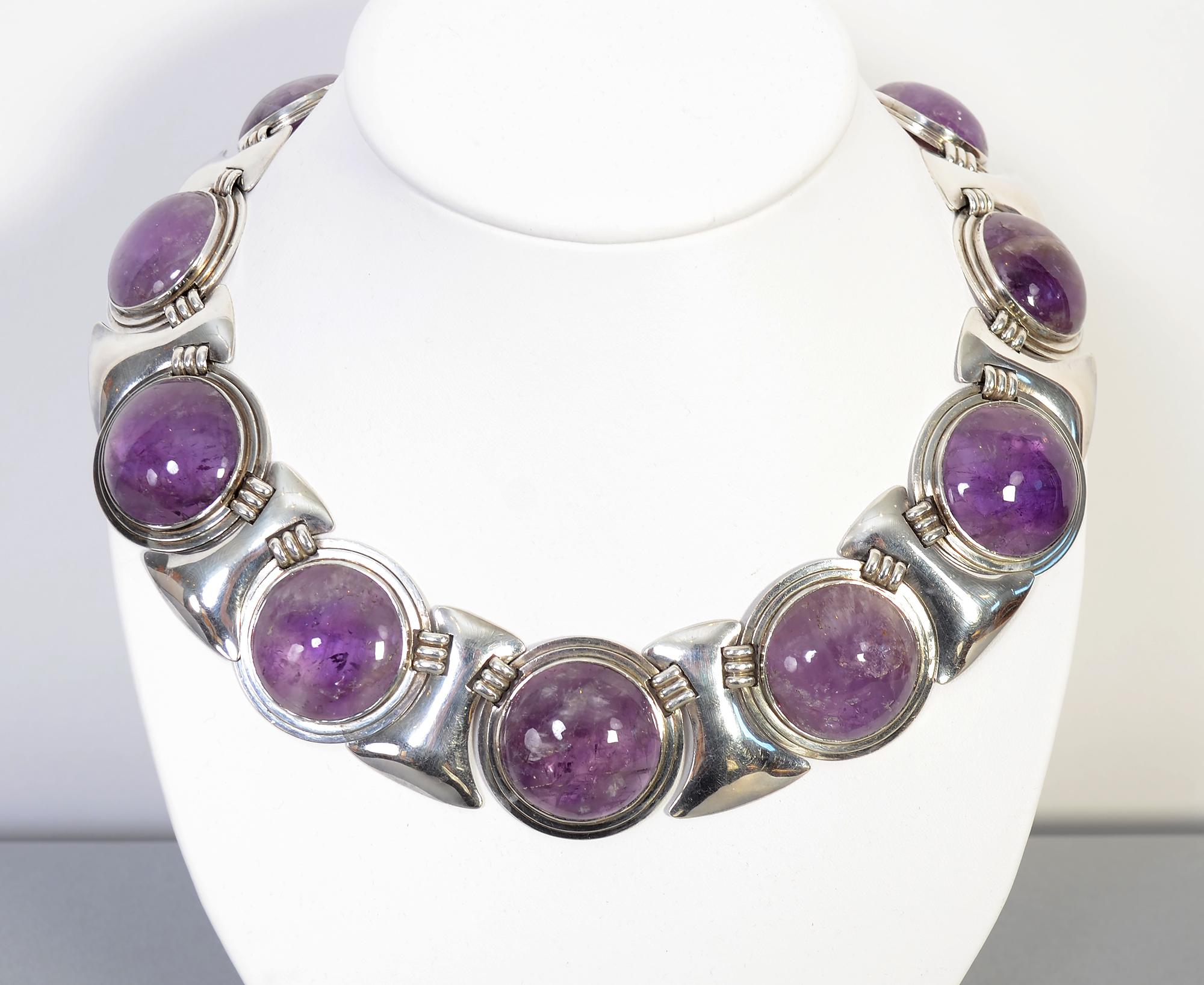 This silver and amethyst circles necklace by Fred Davis is one of his iconic designs. What makes this example stand out is the exceptional size. It is much larger than the standard. Each round disc is 1 1/2 inches in diameter making for a very