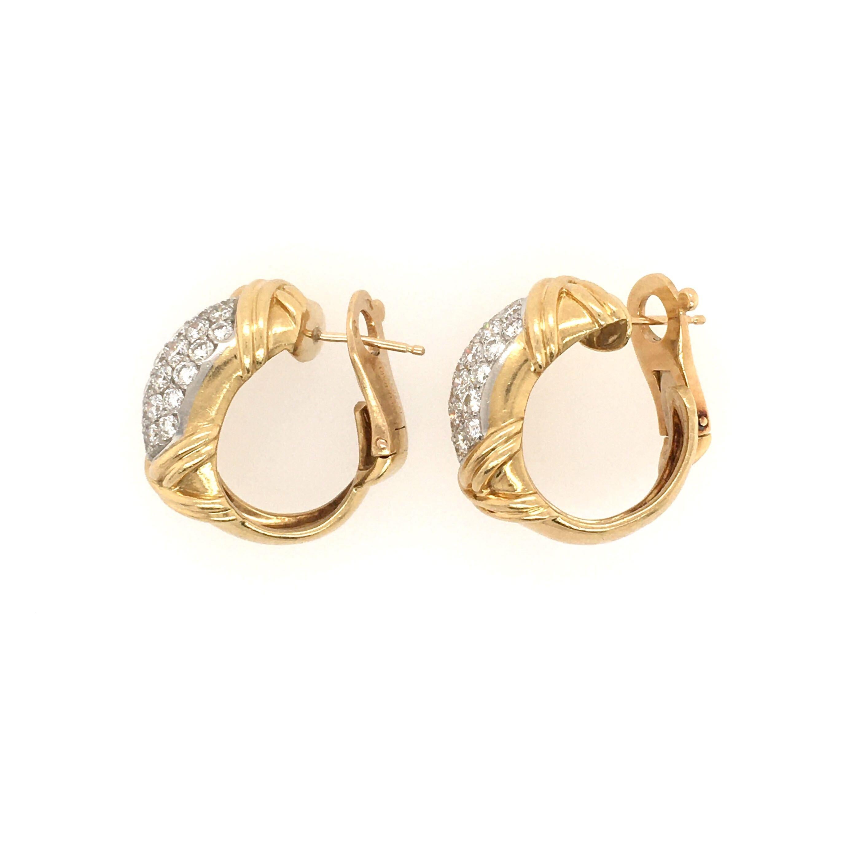 A pair of 18 karat yellow gold and diamond earrings. Fred. Paris. Designed as a hoop, enhanced by pave set diamonds and X motifs. Fifty eight (58) diamonds weigh approximately 2.90 carats. Length is approximately 7/8 inch. Gross weight is