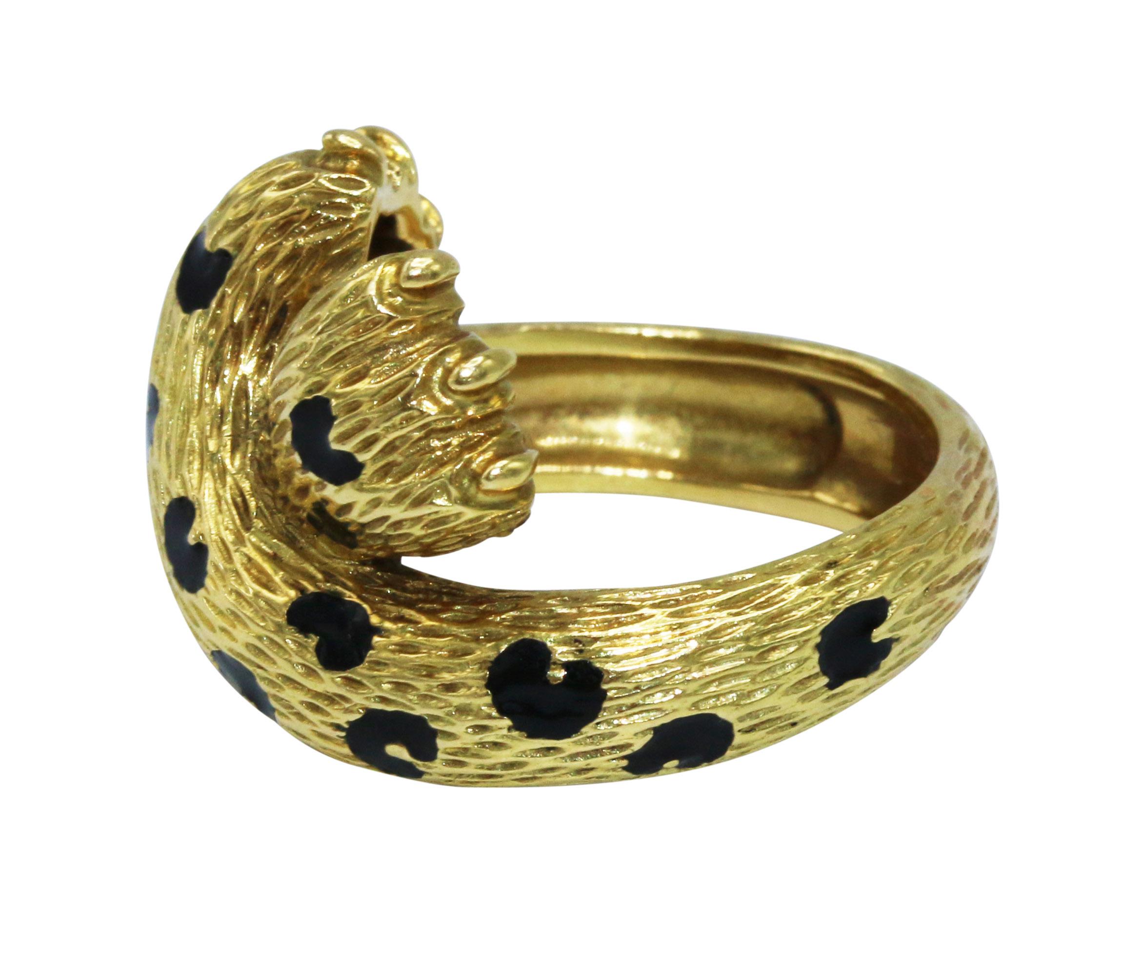 18 karat yellow gold and enamel panther ring by Fred, Paris, designed as two crossed panther paws applied with black enamel spots, gross weight 10.2 grams, size 6, signed Fred France, with French assay and workshop marks.
The ring is incredibly well