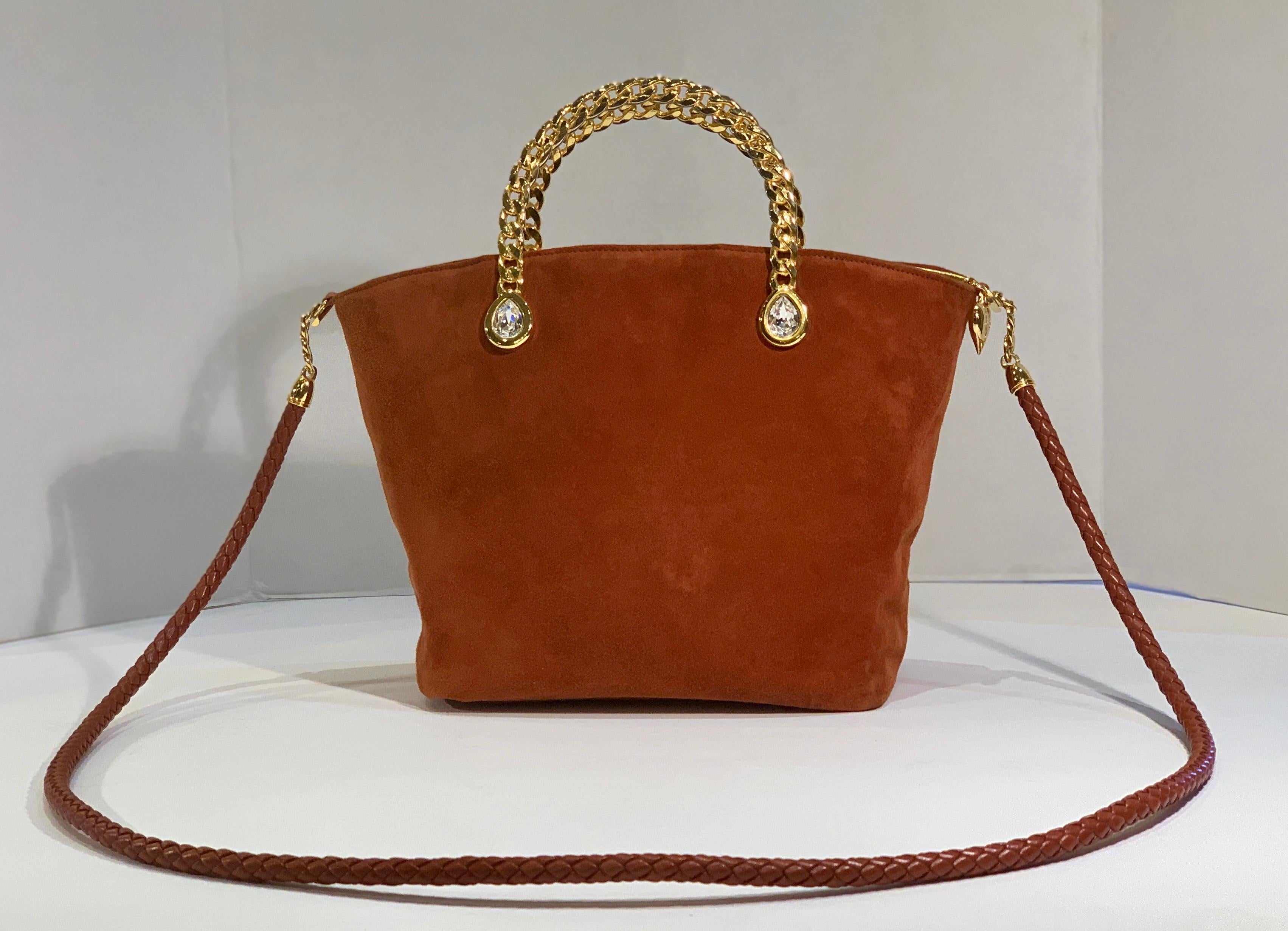 Luxurious, ultra-soft suede handbag or evening purse from Fred Hayman Beverly Hills, the creator of Giorgio Beverly Hills.  Small bucket style bag features large, pear shape Swarovski crystal embellishments, bezel set in shiny gold color metal