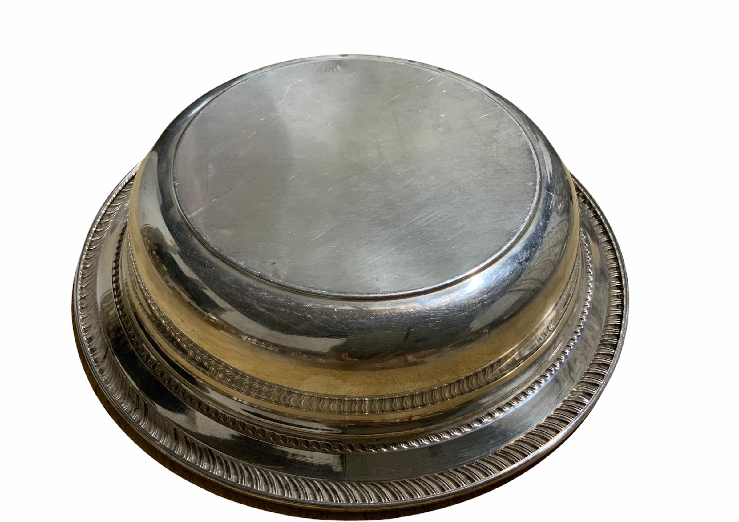 This is a Fred Hirsch & Co. Sterling dish bowl. It is adorned in the top with a gadrooning border, followed by a flat band and then, kind of a rope design. Below the base is the Fred Hirsch & Co. hallmark.