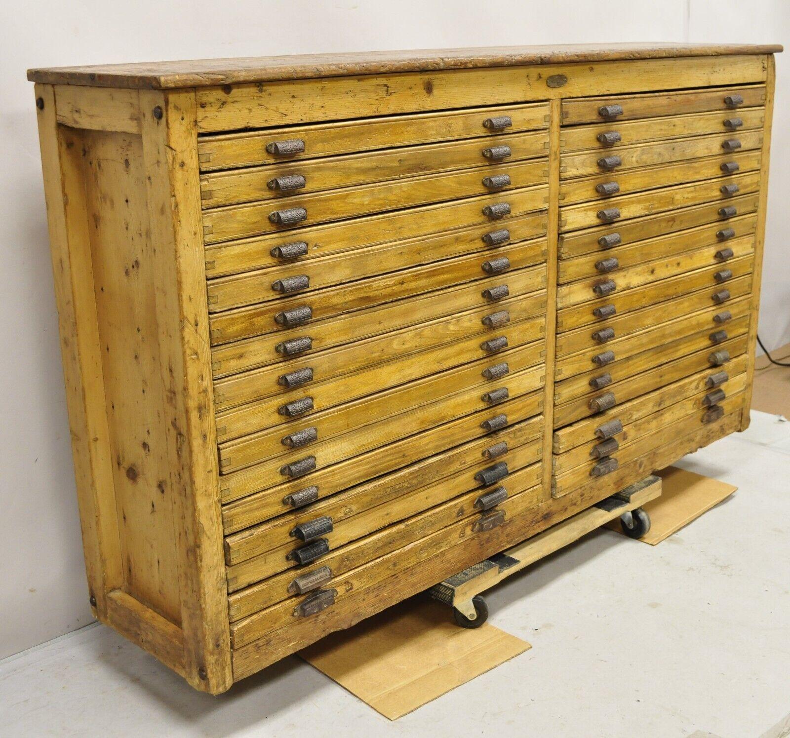 Rare Antique Fred K. Ullmer London Double 32 Drawer Map Makers Flat File Printers Cabinet. Item features 32 drawers with various partitions (some with separators some without), planked wood back, cast iron hardware, original branding, believed to be