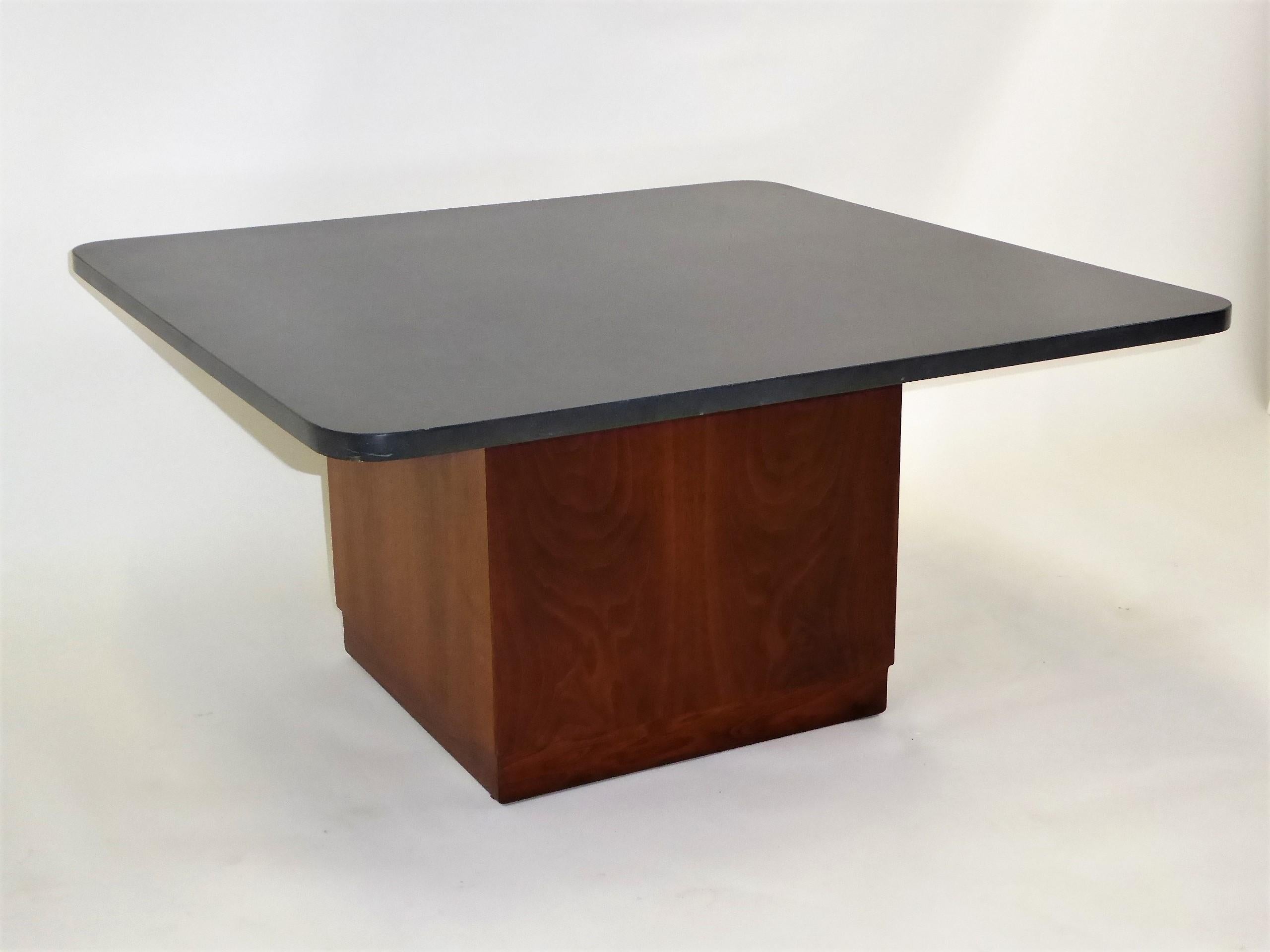 A Mid-Century Modern Coffee or Cocktail Table featuring a 1 inch thick square slate top with a square walnut base by St. Louis architect, Fred Kemp. Beautiful figured walnut veneers highlight this table. Neutral gray slate with rounded edges adds