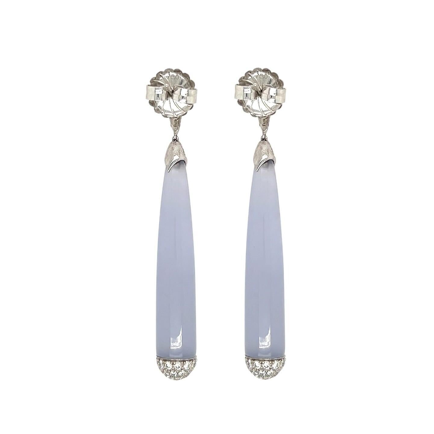 A pair of 18 karat white gold, blue chalcedony and diamond earrings, Fred Leighton.  Each earring designed as an inverted drop shape pave set with approximately 31 round brilliant cut diamonds suspending an elongated drop of blue chalcedony the cap