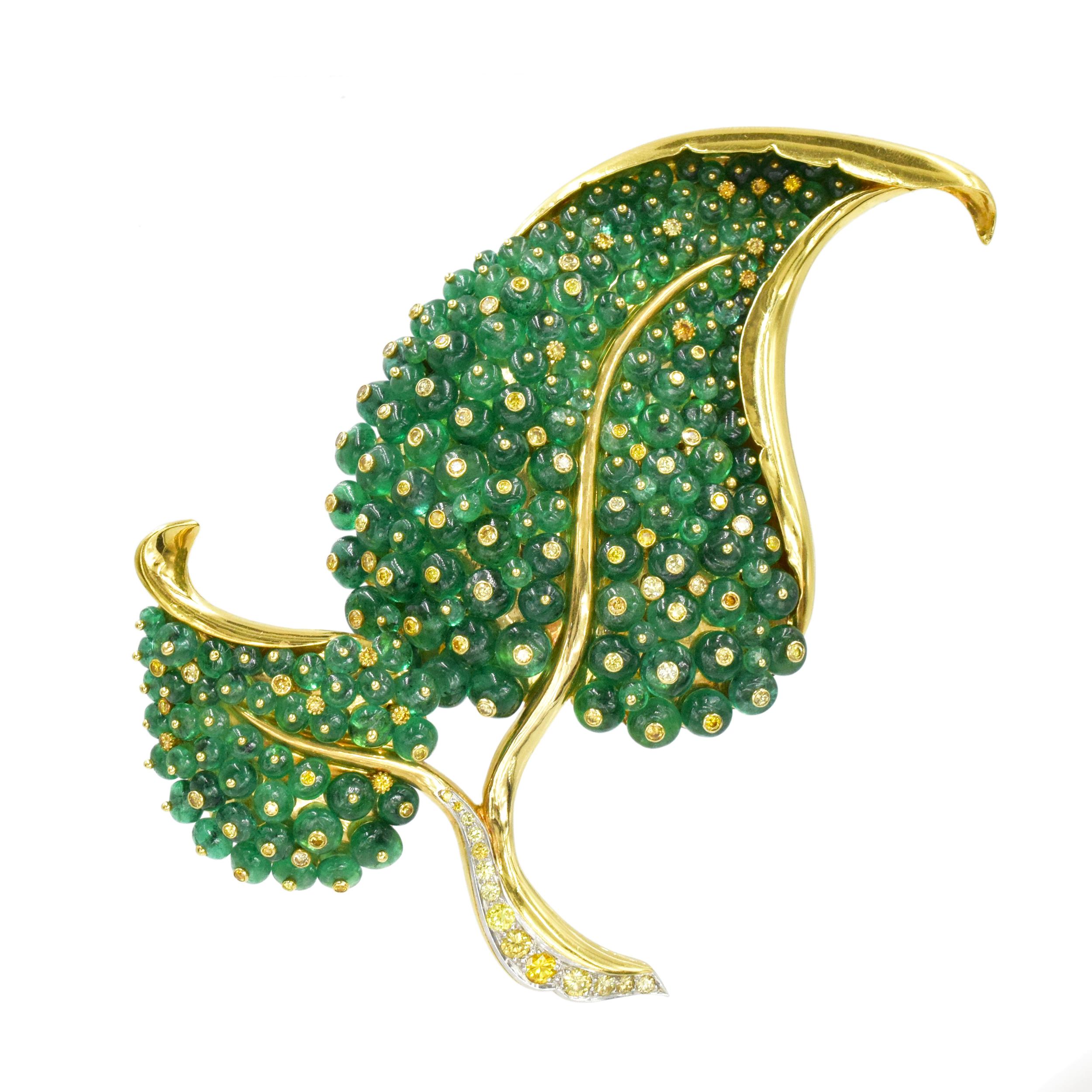 Fred Leighton Gold, Emerald and Colored Diamond Brooch In 18k Yellow Gold. This brooch is created in a foliate design, adorned with emerald beads with total weight of approximately 40- 50ct. Round brilliant cut yellow diamonds with total weight of