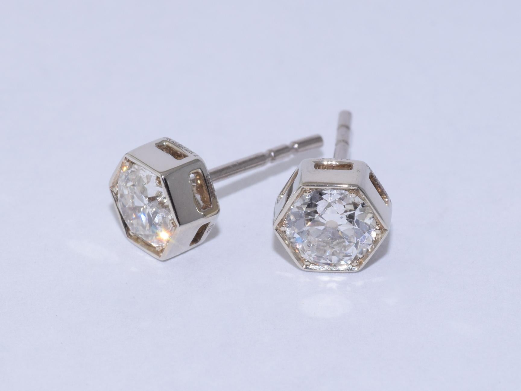 Stud earrings are set with two old European diamonds totaling 1.02 carats, of approximately FG/SI quality, mounted in 18K white gold hexagonal frame, signed Fred Leighton. The earrings measure approximately 5.8 x 6.5mm (approximately 0.25