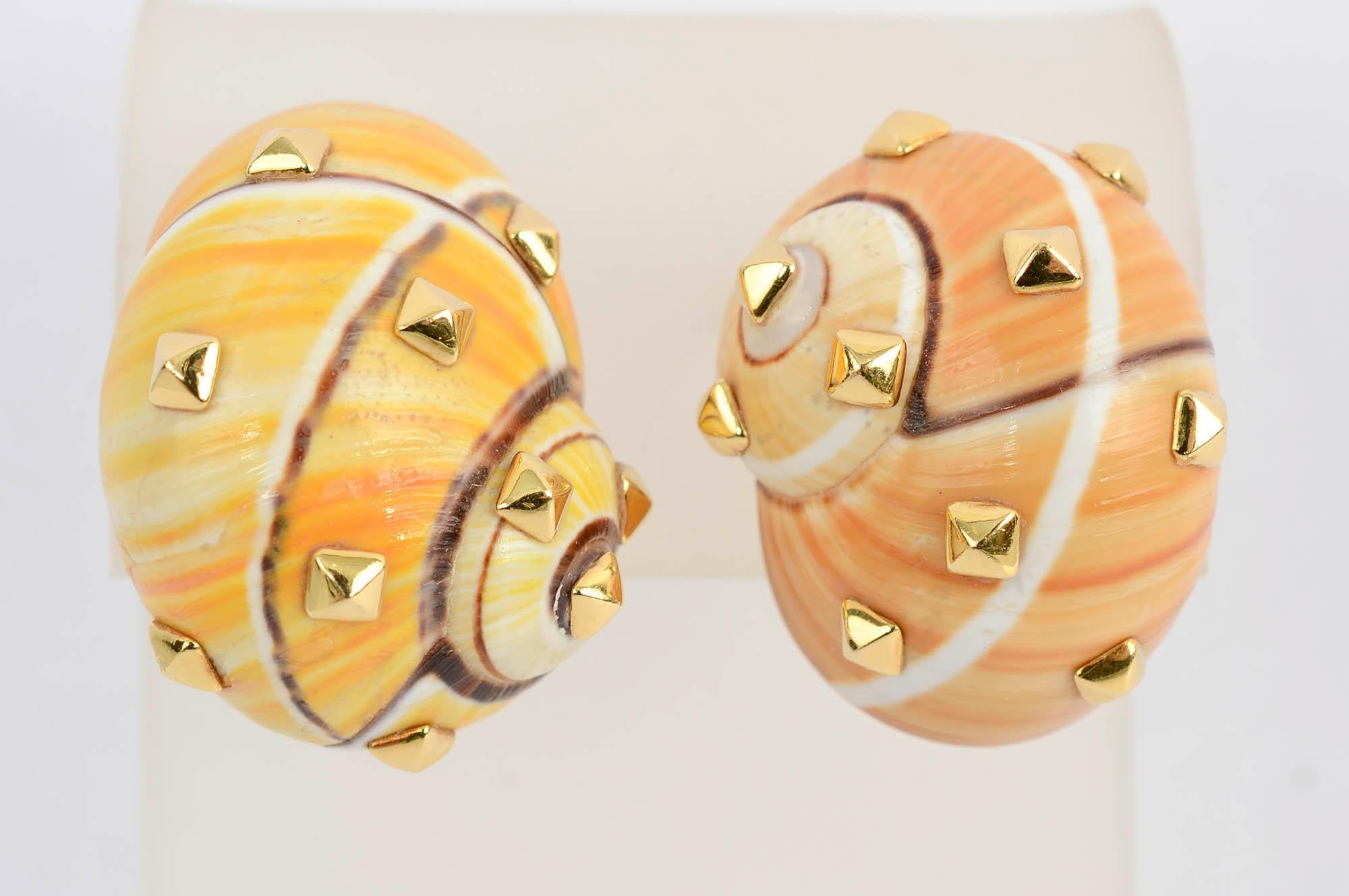 Very chic shell earrings with pyramidal gold medallions by Fred Leighton. The  shells are natural so they are not the exact same color. Backs are clips that can be converted to posts.
The earrings measure 3/4