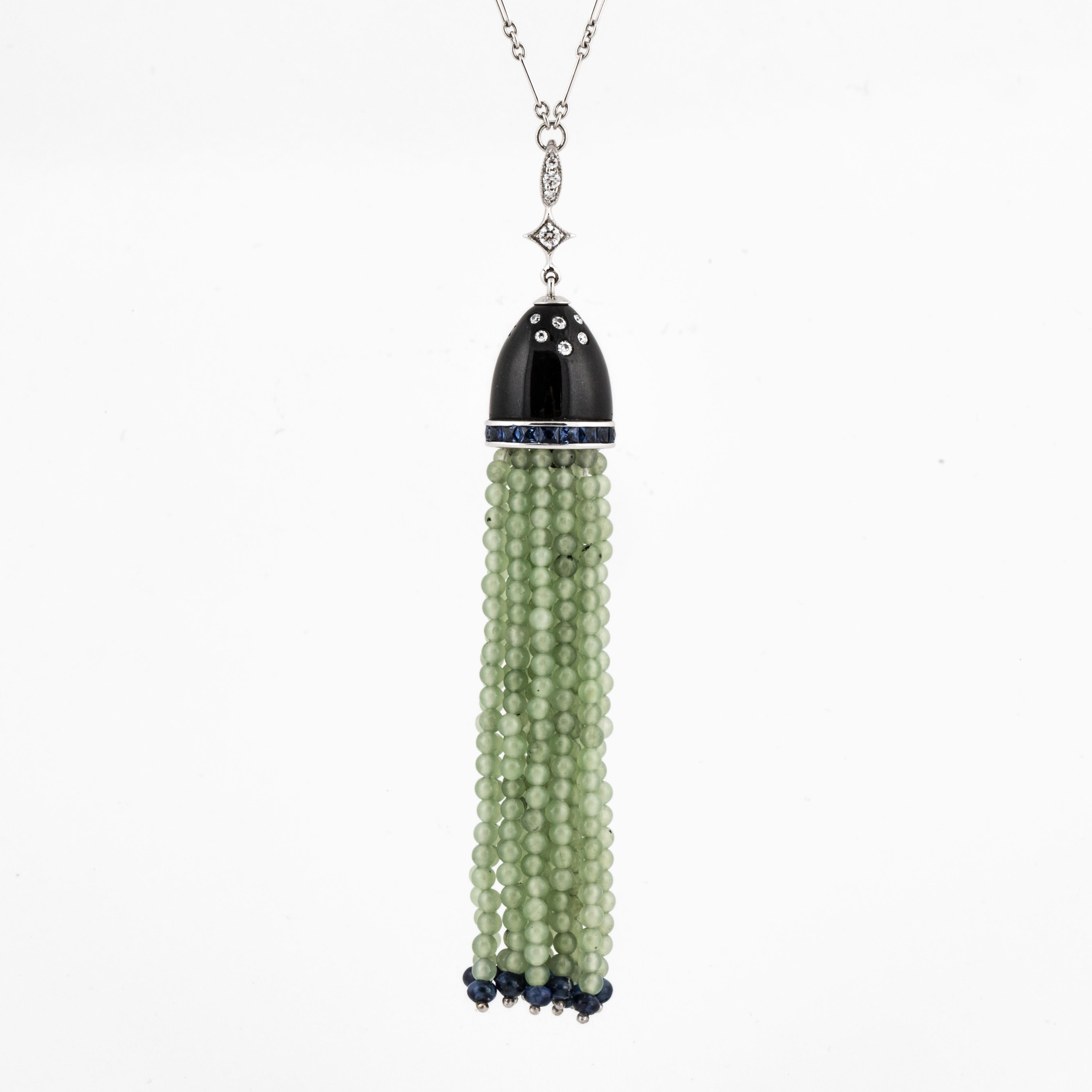 Fred Leighton tassel pendant necklace in 18K white gold composed of diamonds, sapphires, onyx and jade with black enamel.  There are 13 strands of nephrite jade beads, accented with sapphire beads and calibré cut sapphires that total 1.40 carats. 