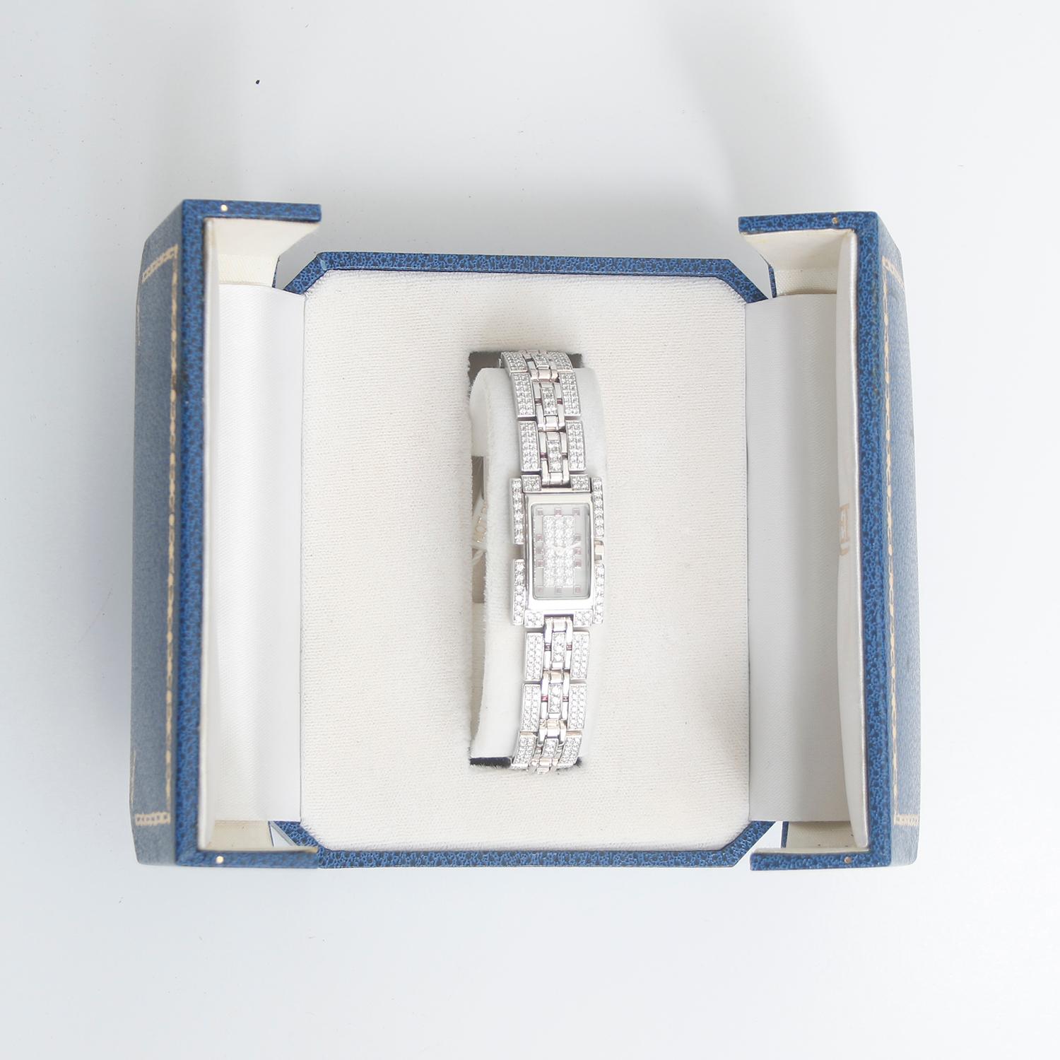 Fred of Paris 18K White Gold Pave Diamond Ladies Watch - Quartz. 18K White Gold with pave diamonds ( 28 x 18 mm ). Ivory dial with pave diamonds and rubies as hour markers. 18K White gold with diamonds and rubies; will fit up to a 6 1/2 inch wrist.