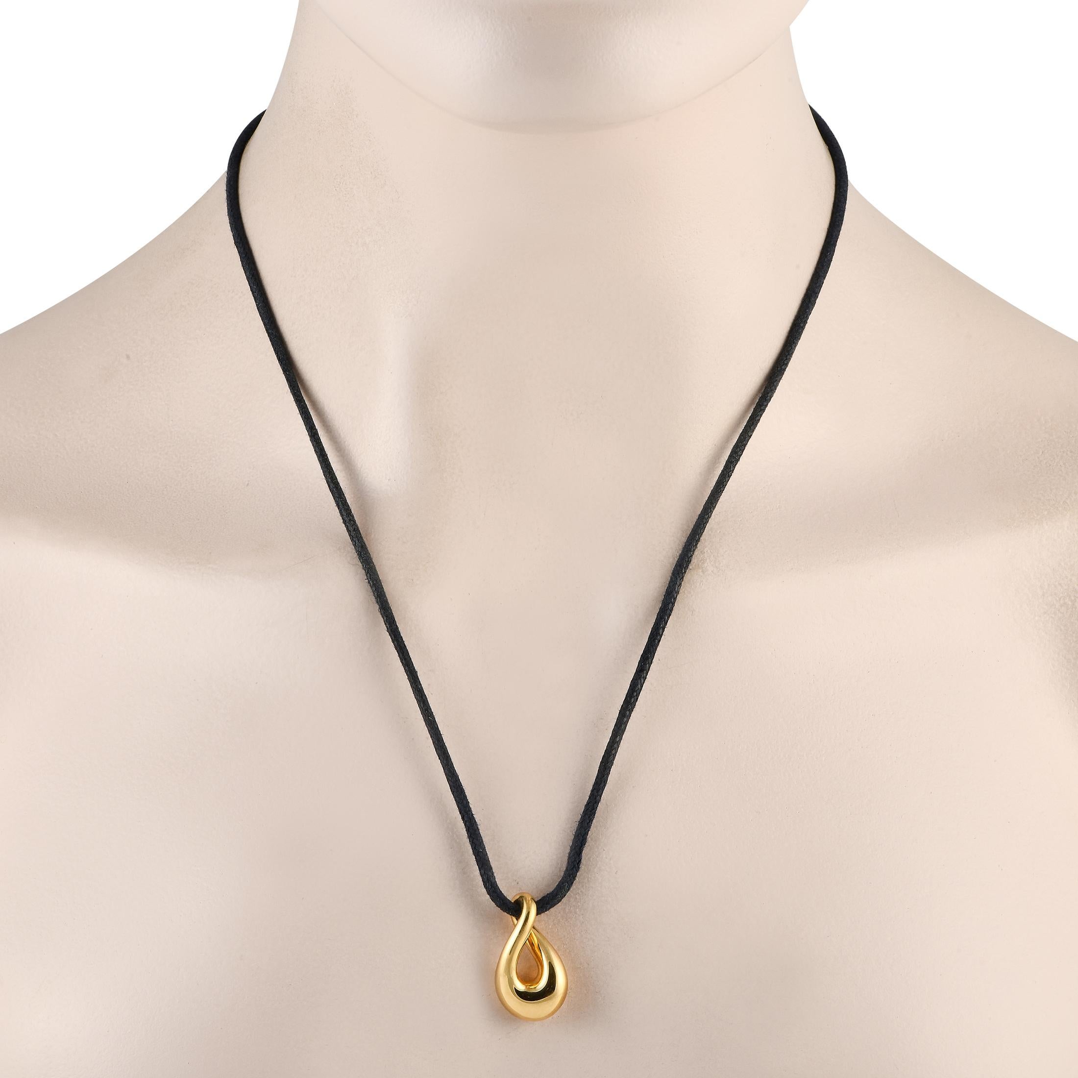 From Paris-founded jewelry brand, here is a contemporary necklace to suit the style of a cool and edgy fashionista. This piece features a stylized infinity swirl pendant in solid 18K yellow gold, held by a black cord.This Fred of Paris 18K Yellow