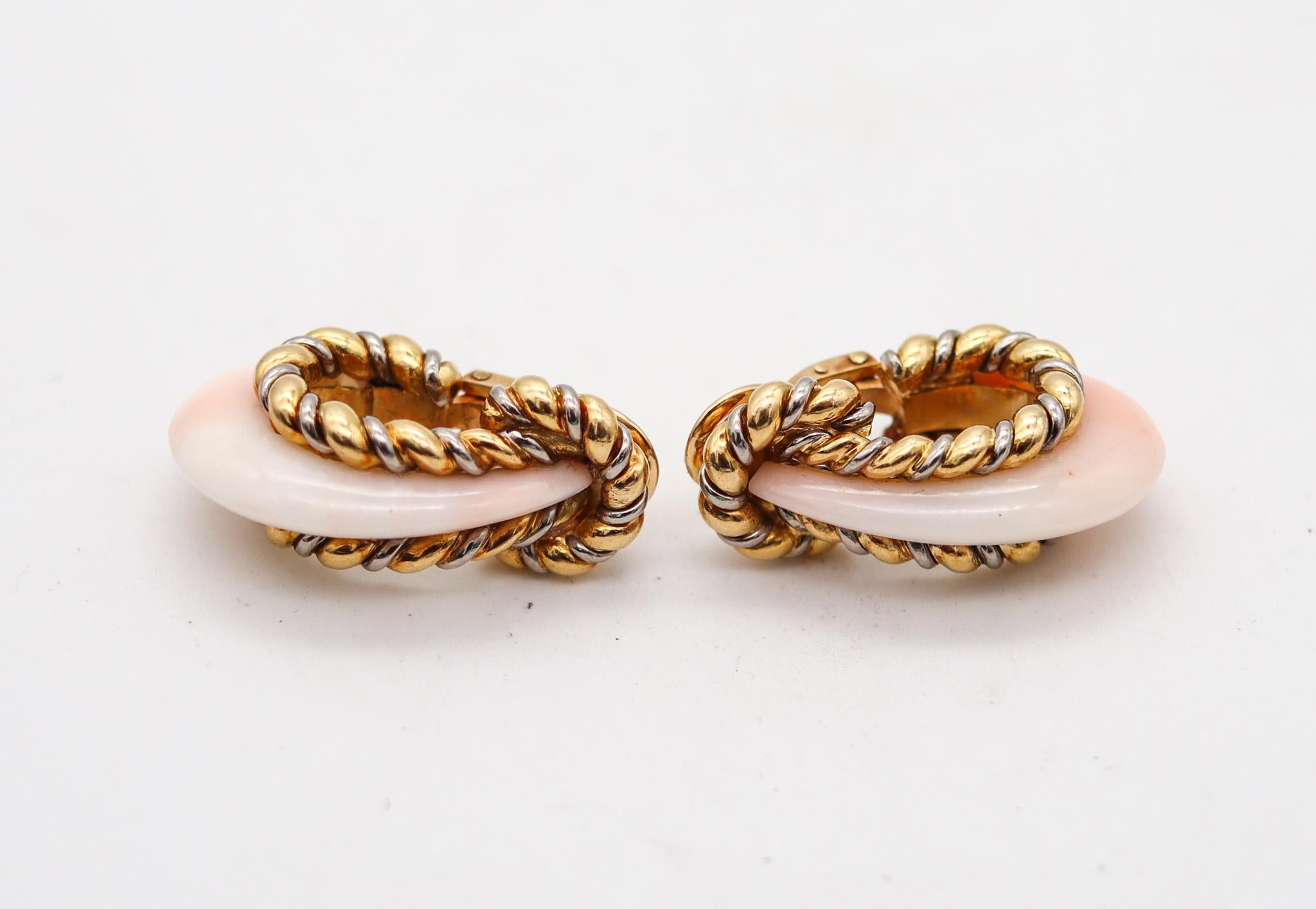 Hoop earrings with corals designed by Fred of Paris.

Fabulous pair of clips earrings, created in Paris France by the jewelry house of Fred Joaillier, back in the 1970. These earrings has been made with classical fluted patterns by twisted wires