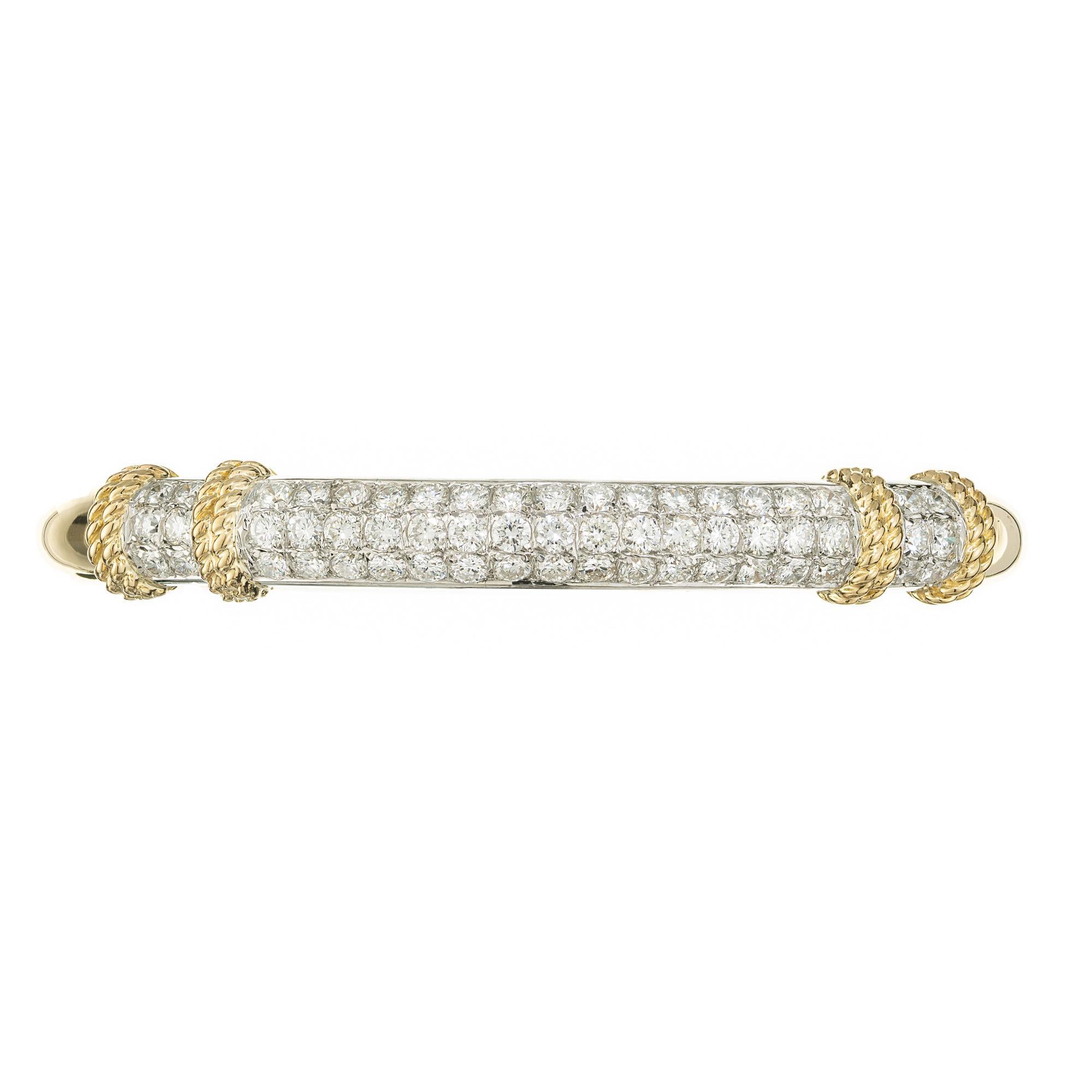 Vintage 1970's Fred of Paris France diamond bangle bracelet. 57 round brilliant cut diamonds aligned in 3 rows framed with 18k white gold and 18k yellow gold twisted wire accents. The rest of this dazzling bangle is made in 18k yellow gold.

57