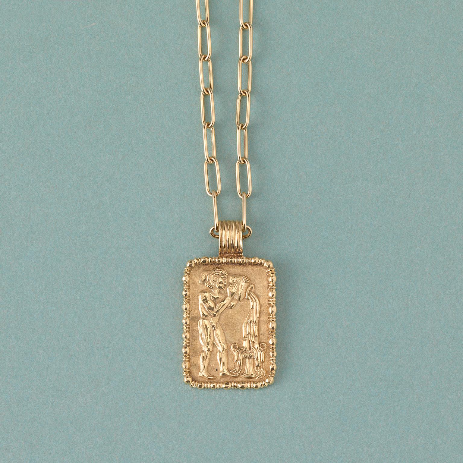 An 18 carat rectangular gold aquarius zodiac charm, signed: Fred, Paris, circa 1970.

weight: 14.5 gram
dimensions: 4 x 2 cm