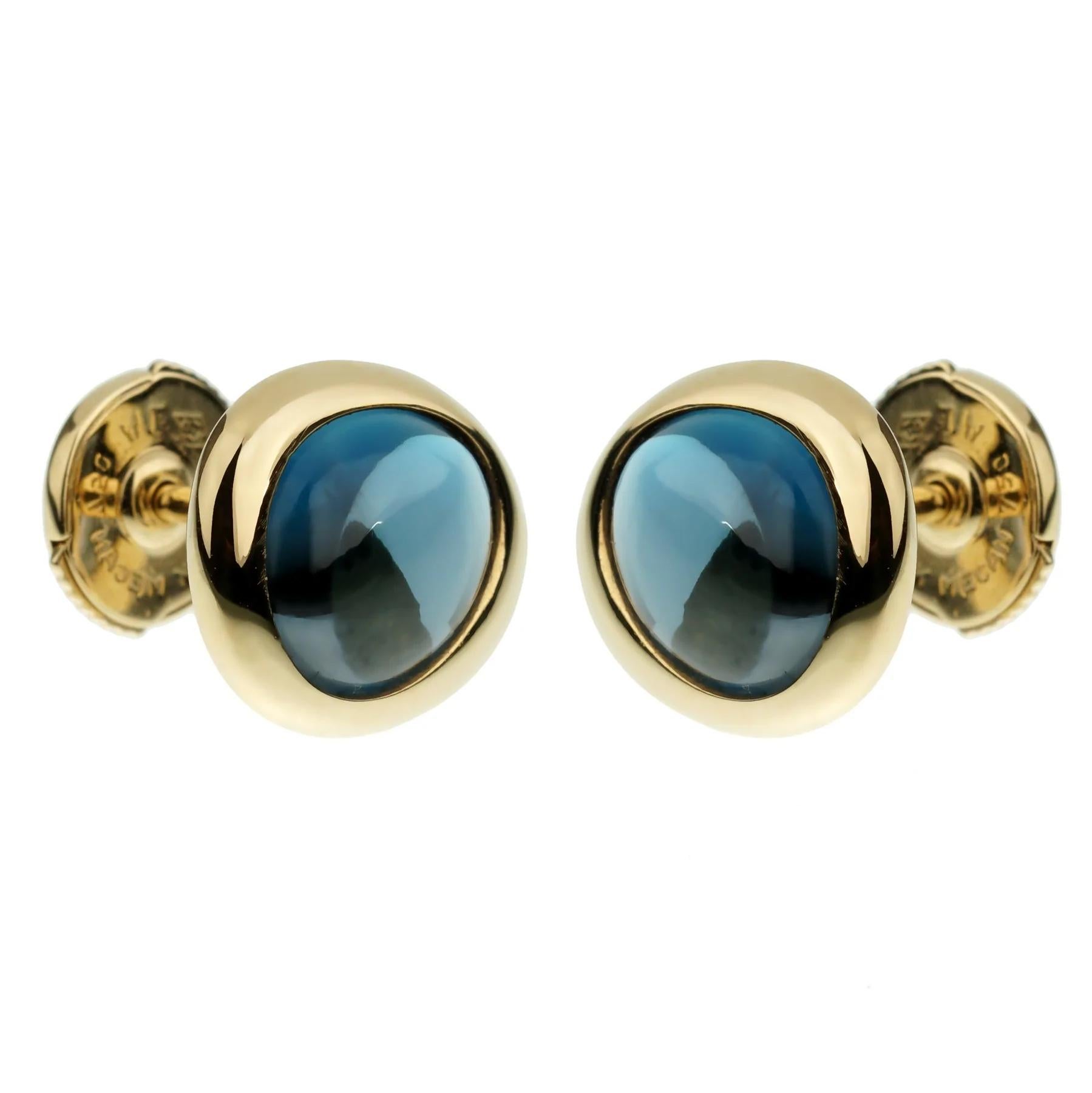 A fabulous pair of Fred of Paris yellow gold stud earrings showcasing 2 cabochon blue topaz stones set in 18k yellow gold. The earrings measure .47