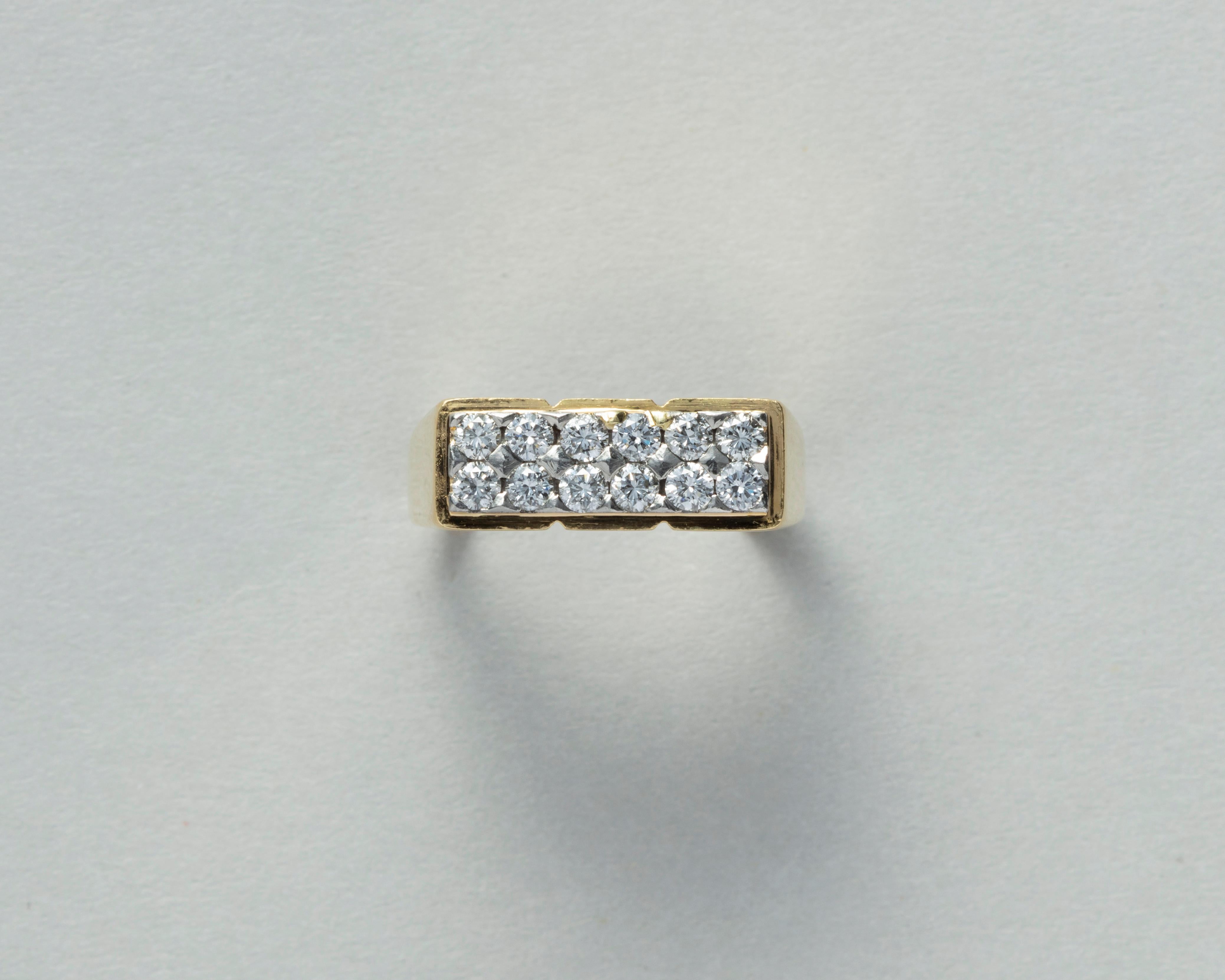 An 18 carat gold ring with a rectangular top set with two rows of 6 brilliant cut diamonds (appr. 0.48 carat in total) in white gold the upper part of the ring is divided in 3 parts. signed: Fred, Paris circa 1970.

weight: 8.12 grams
ring size: