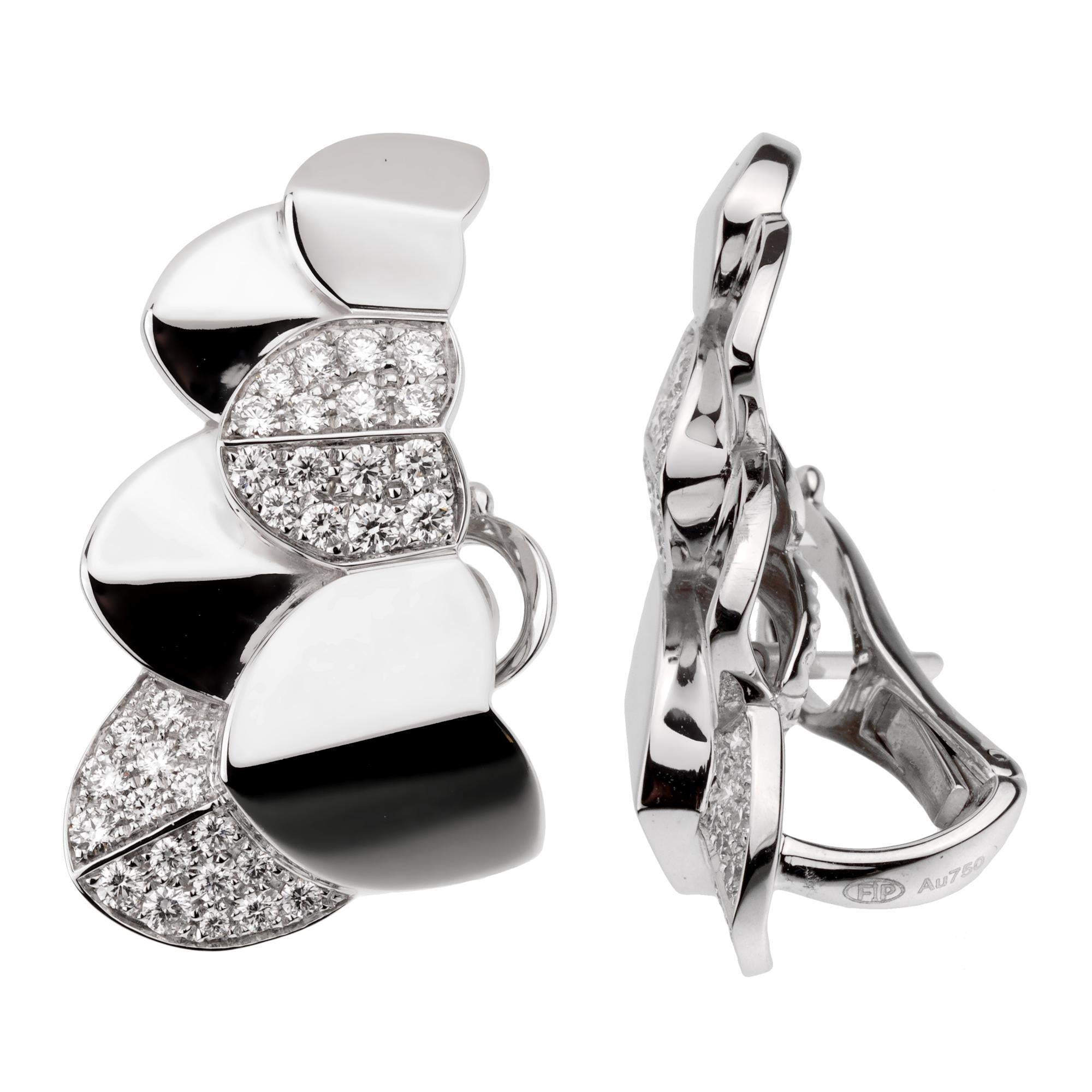 A fabulous brand new pair of Fred of Paris earrings showcasing a double arc motif in shimmering 18k white gold adorned with round brilliant cut diamonds. (.88ct) The earrings have a length of 1.10