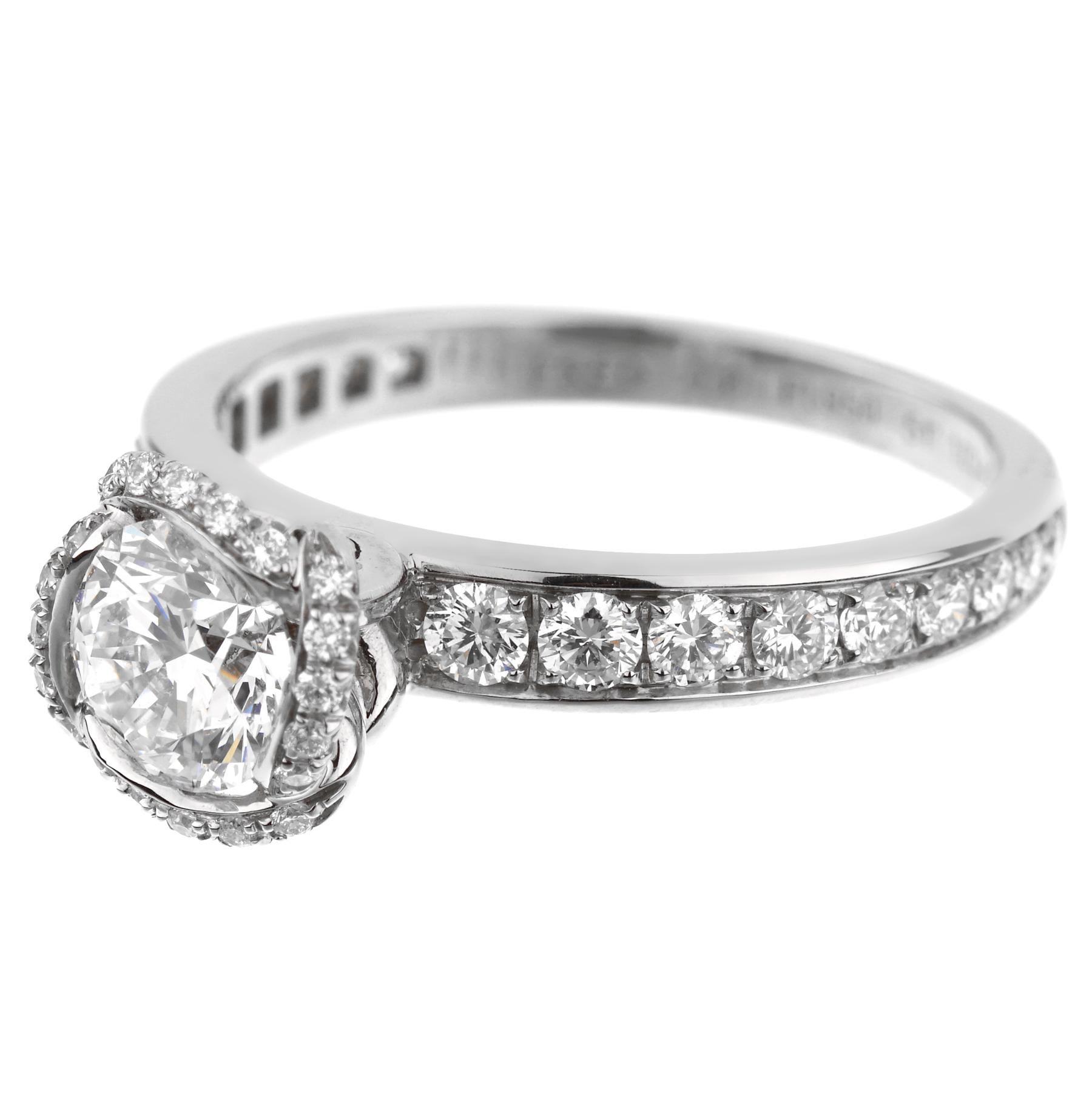 A chic Fred of Paris diamond engagement ring from the Fleur Celeste collection showcasing a .71ct GIA certified solitaire G color Vvs2 clarity adorned with .52ct of round brilliant cut diamonds set in platinum. The ring measures a size 6 and can be